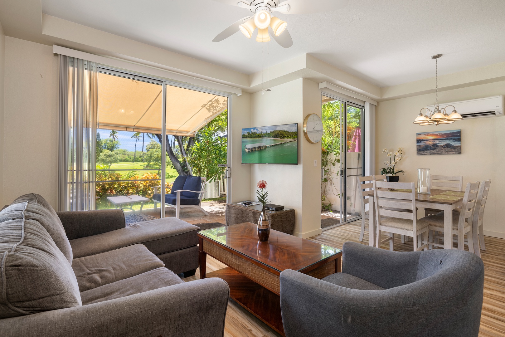 Relax in your bright, contemporary living space with patio doors opening to tropical garden views.