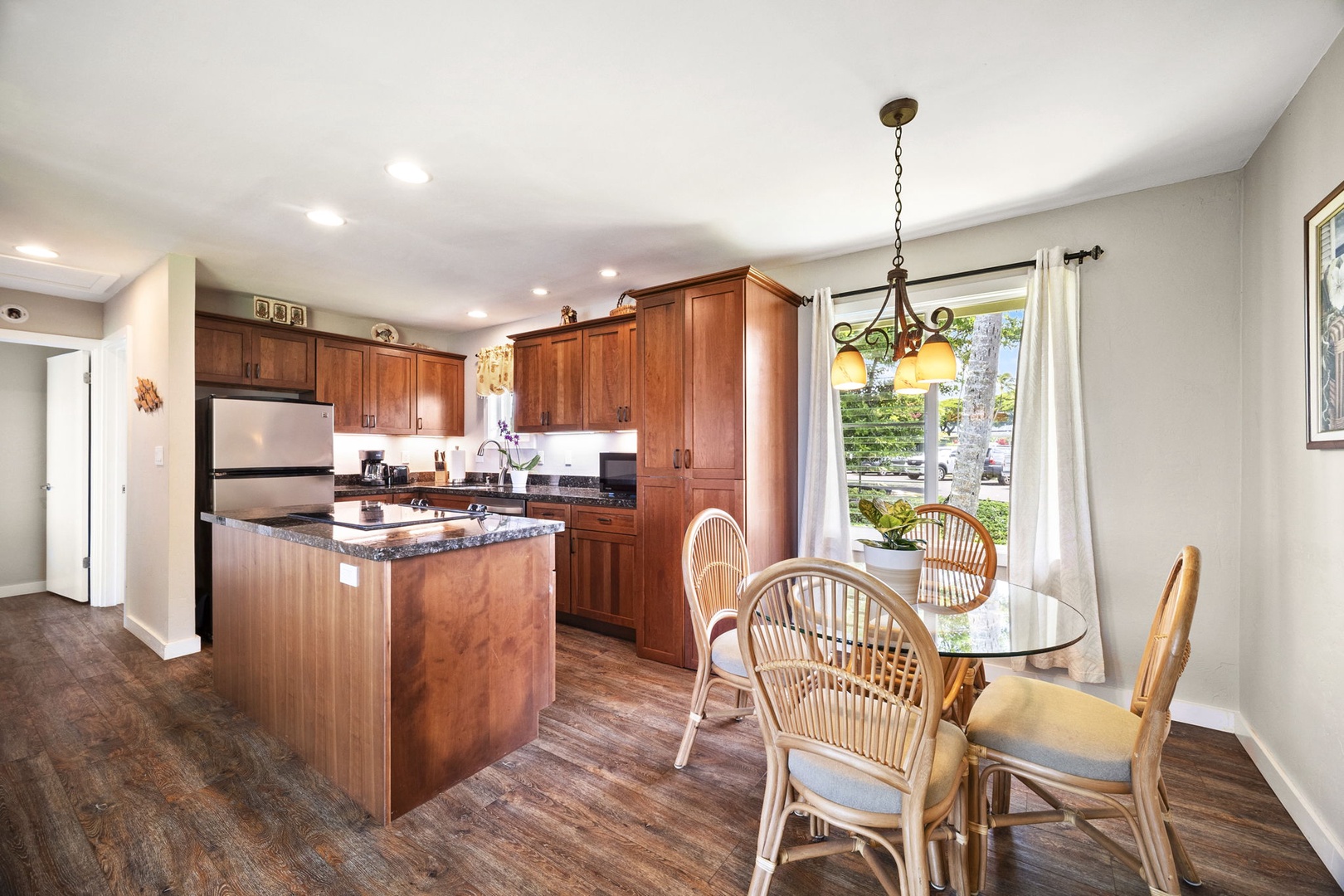 Princeville Vacation Rentals, Alii Kai 7201 - Rattan chairs pull up to a table off the kitchen for easy dinners in.