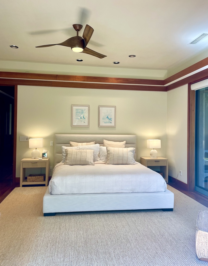 Kamuela Vacation Rentals, Champion Ridge Oasis - Primary bedroom featuring a luxurious king-size bed with a cozy work space, gorgeous ensuite bath, walk-in closet and direct access to the private garden through two large pocket doors.