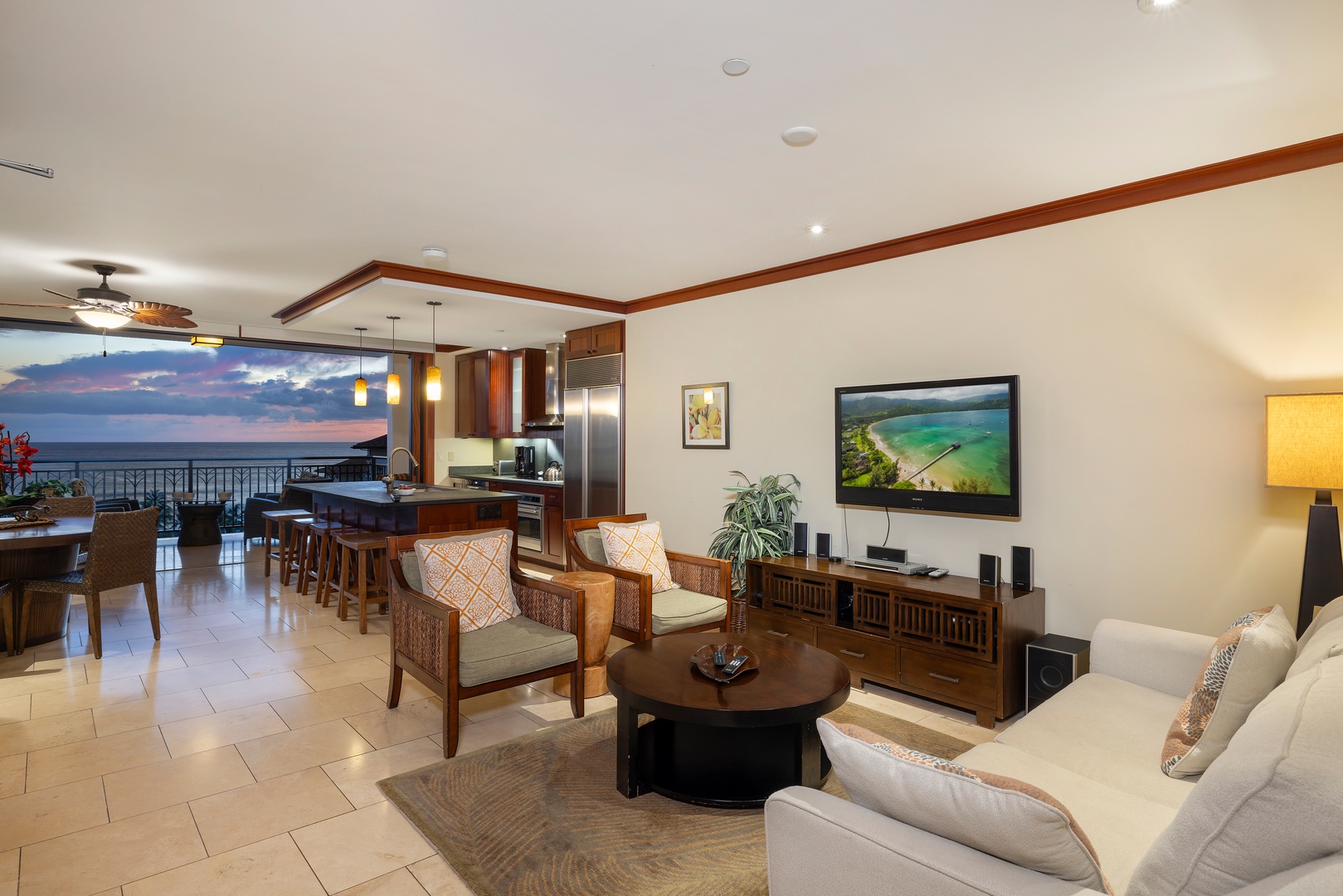Kapolei Vacation Rentals, Ko Olina Beach Villas O1006 - Elegant open-concept living with dining and lounge areas, overlooking a stunning twilight ocean view.