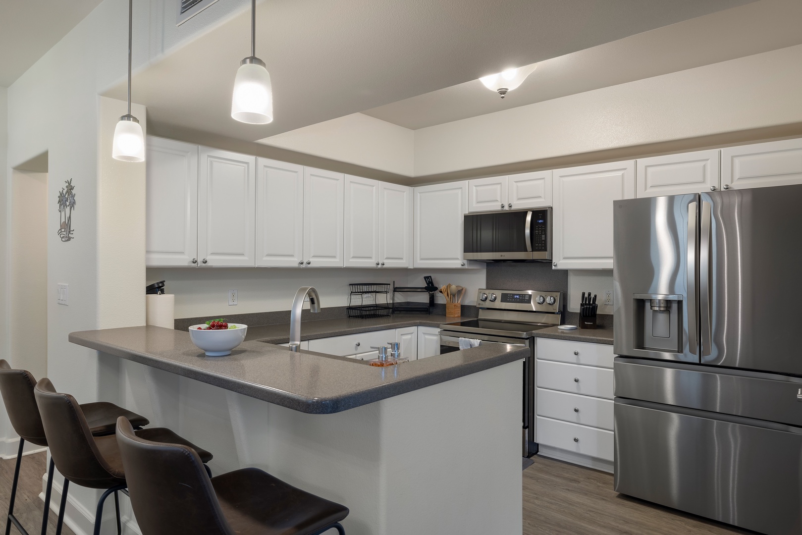Kapolei Vacation Rentals, Ko Olina Kai 1061F - Fully equipped, white kitchen with stainless appliances, ample counter space, and a breakfast bar.