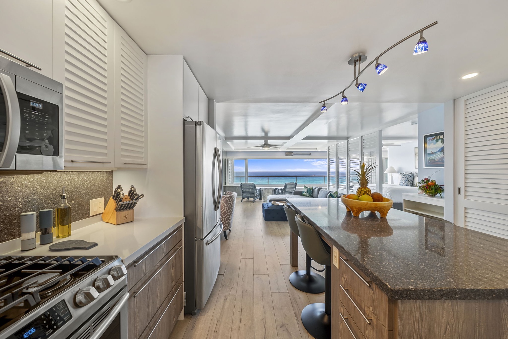 Honolulu Vacation Rentals, Kaimana Tides at Colony Surf - The stunning kitchen flows seamlessly to the living area, where granite counters and modern appliances await your culinary adventures with breathtaking sea views.