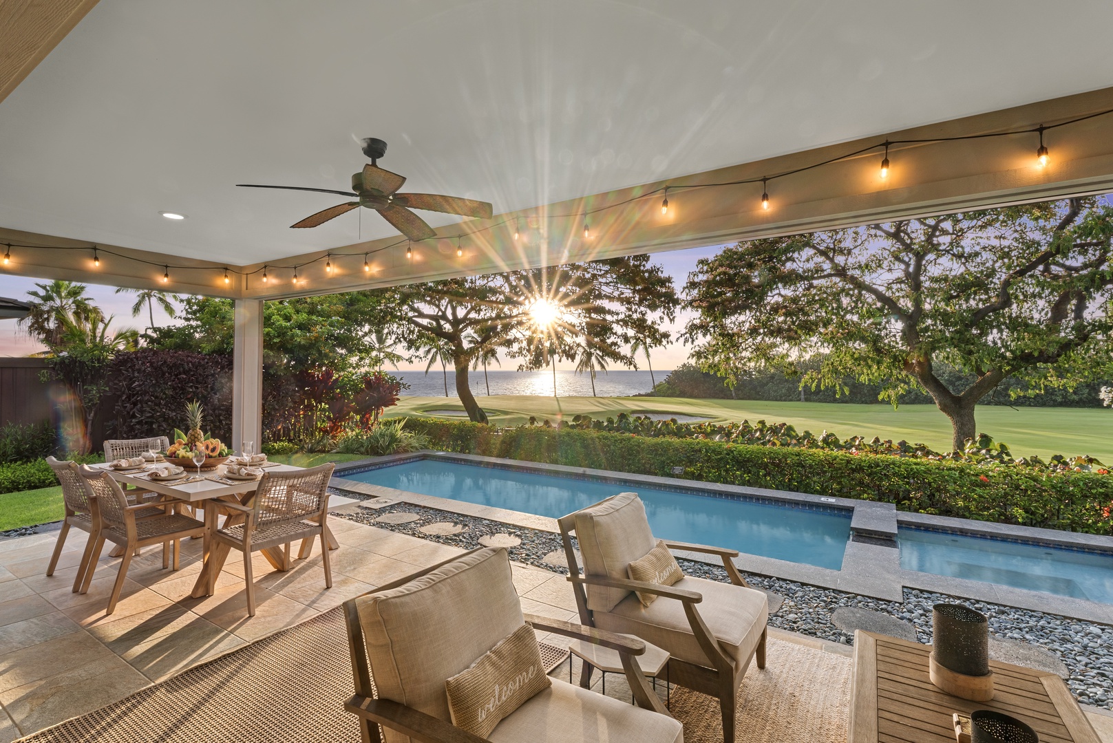 Kailua Kona Vacation Rentals, Holua Kai #27 - Dusk over the lanai, string lights on and the pool glowing blue below.