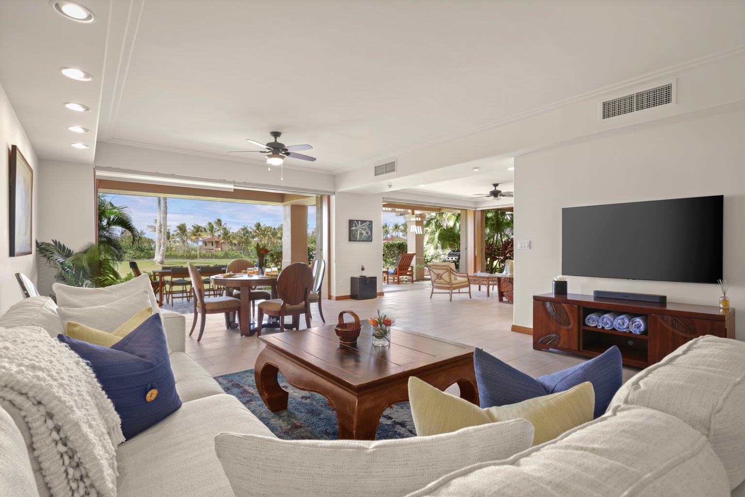 Kailua Kona Vacation Rentals, 3BD Golf Villa (3101) at Four Seasons Resort at Hualalai - Elegant living area with sliding glass pocket doors to lanai seating and ocean views.