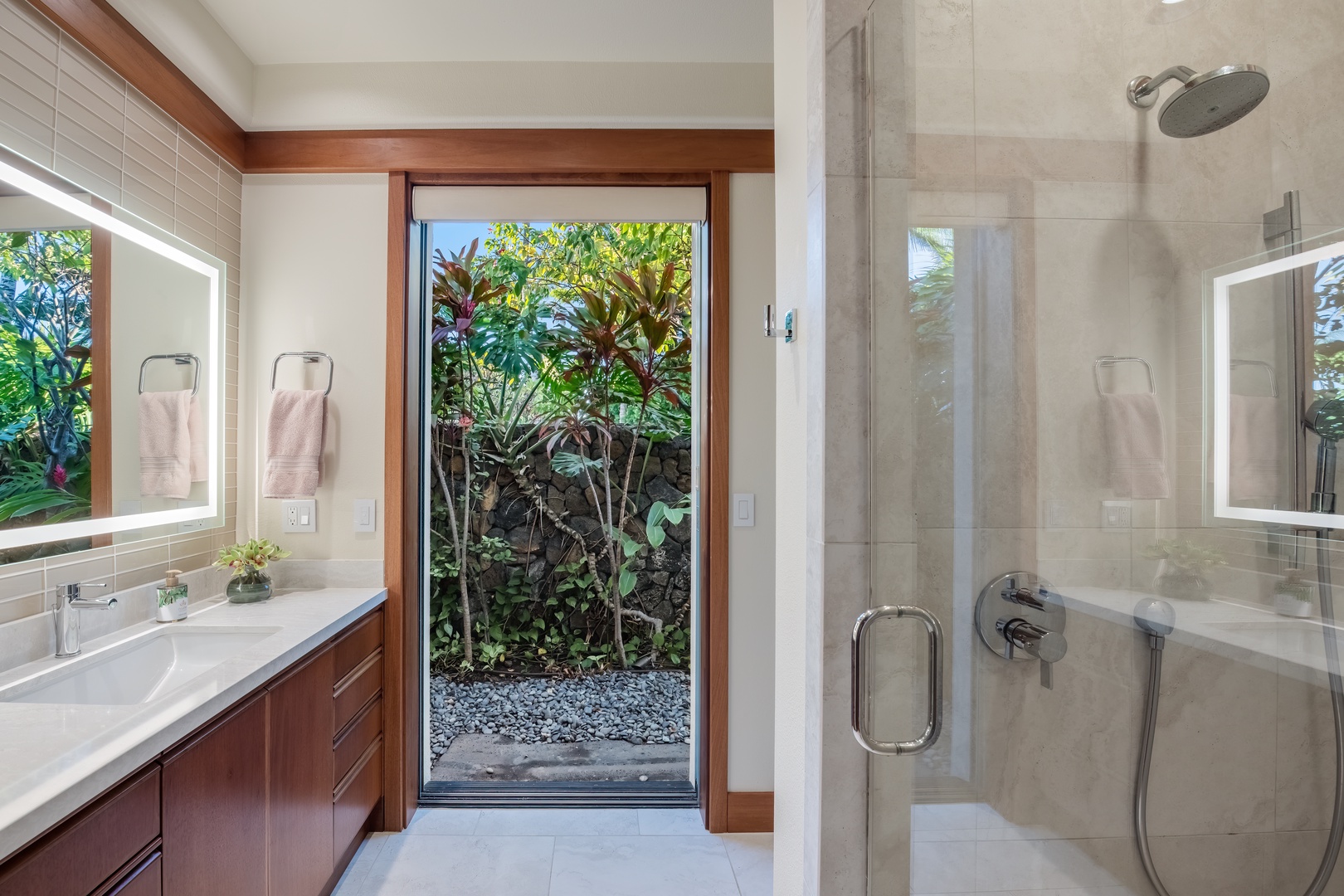 Kamuela Vacation Rentals, Champion Ridge Elegance - Guest Suite 3 modern ensuite bathroom with a glass-enclosed shower and views of lush greenery.