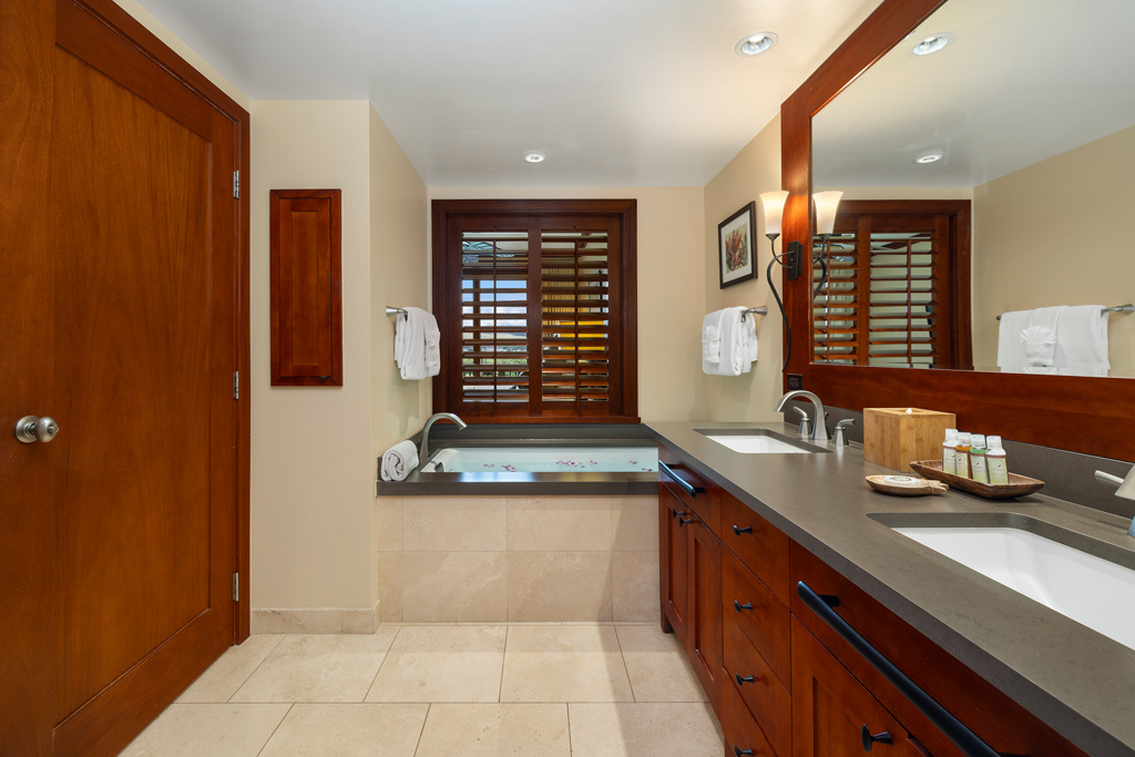 Kapolei Vacation Rentals, Ko Olina Beach Villas O1105 - The primary ensuite features soaking tub, walk in shower and dual vanity with storage.