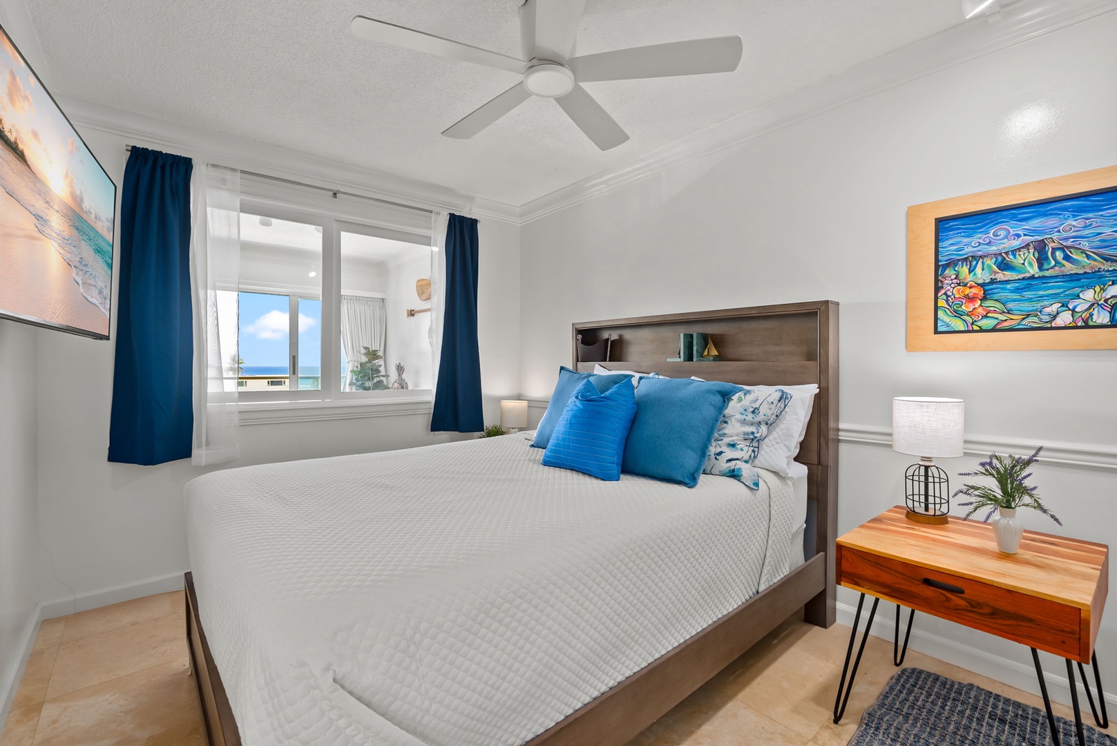 Honolulu Vacation Rentals, Colony Surf Getaway - Cozy primary bedroom with plush bedding and scenic city views, designed for restful nights.