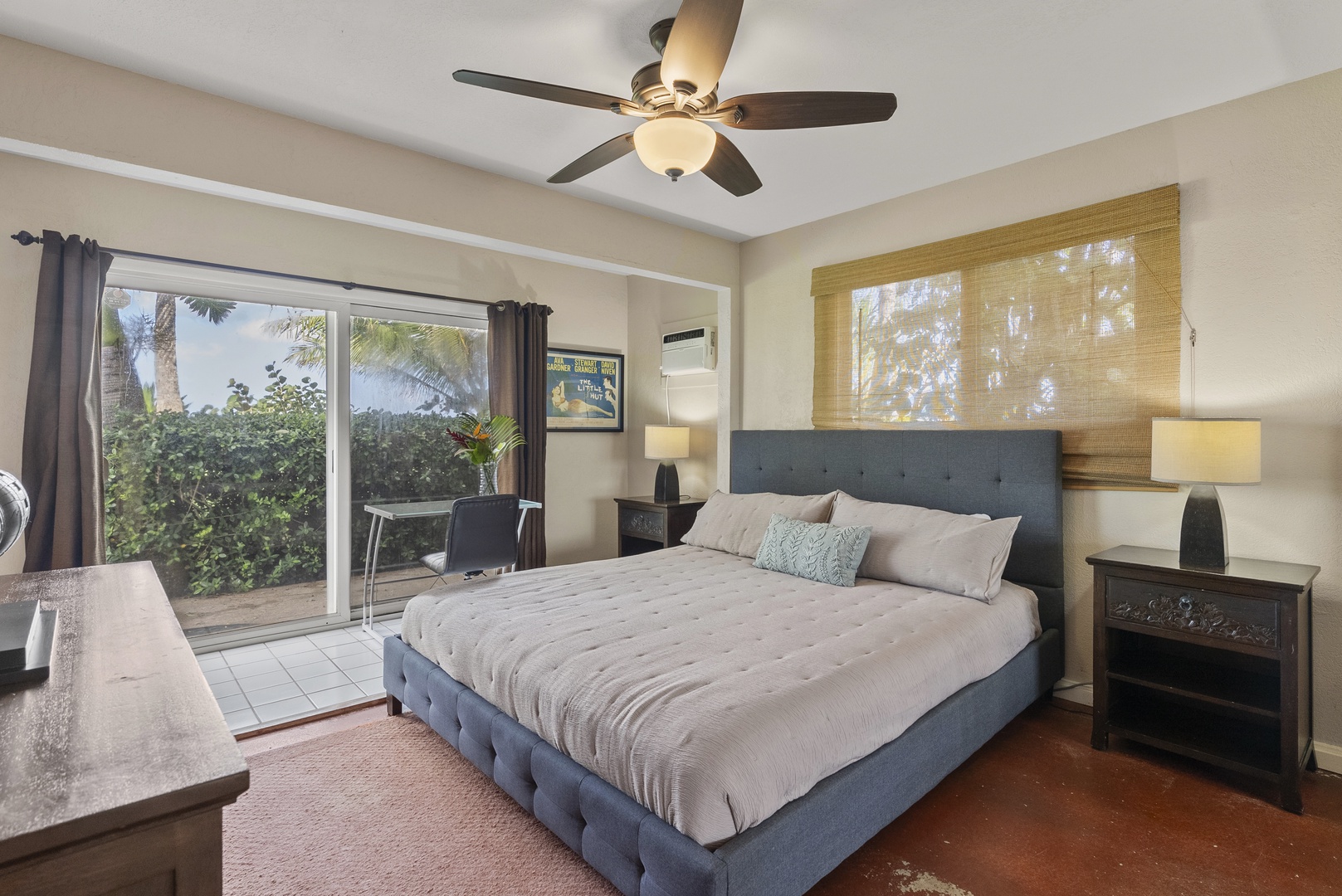 Haleiwa Vacation Rentals, North Shore Beachfront Retreat - Inviting bedroom with a king-size bed and large windows overlooking lush greenery.