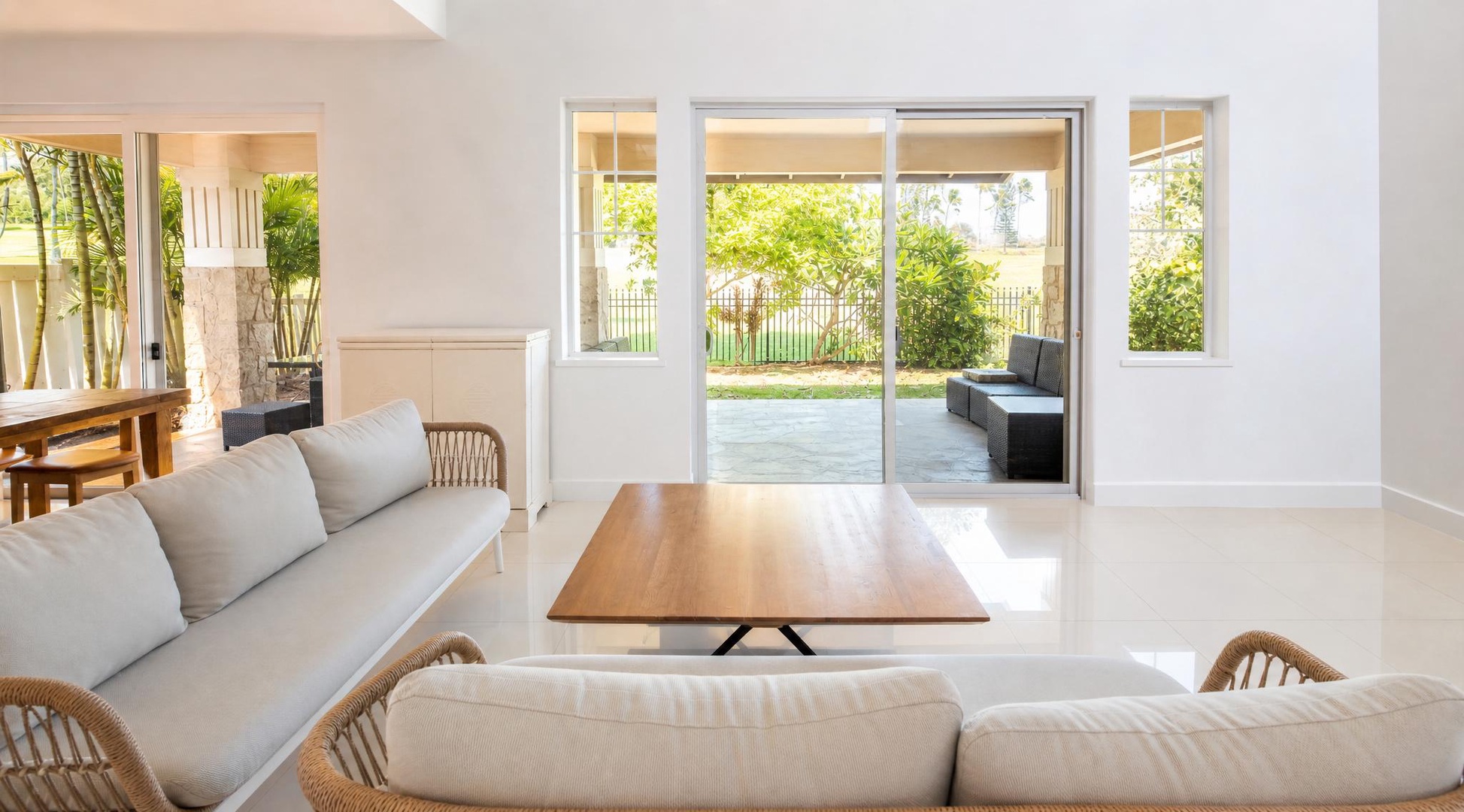 Slide the glass doors open and let the living room spill out toward the greenery.