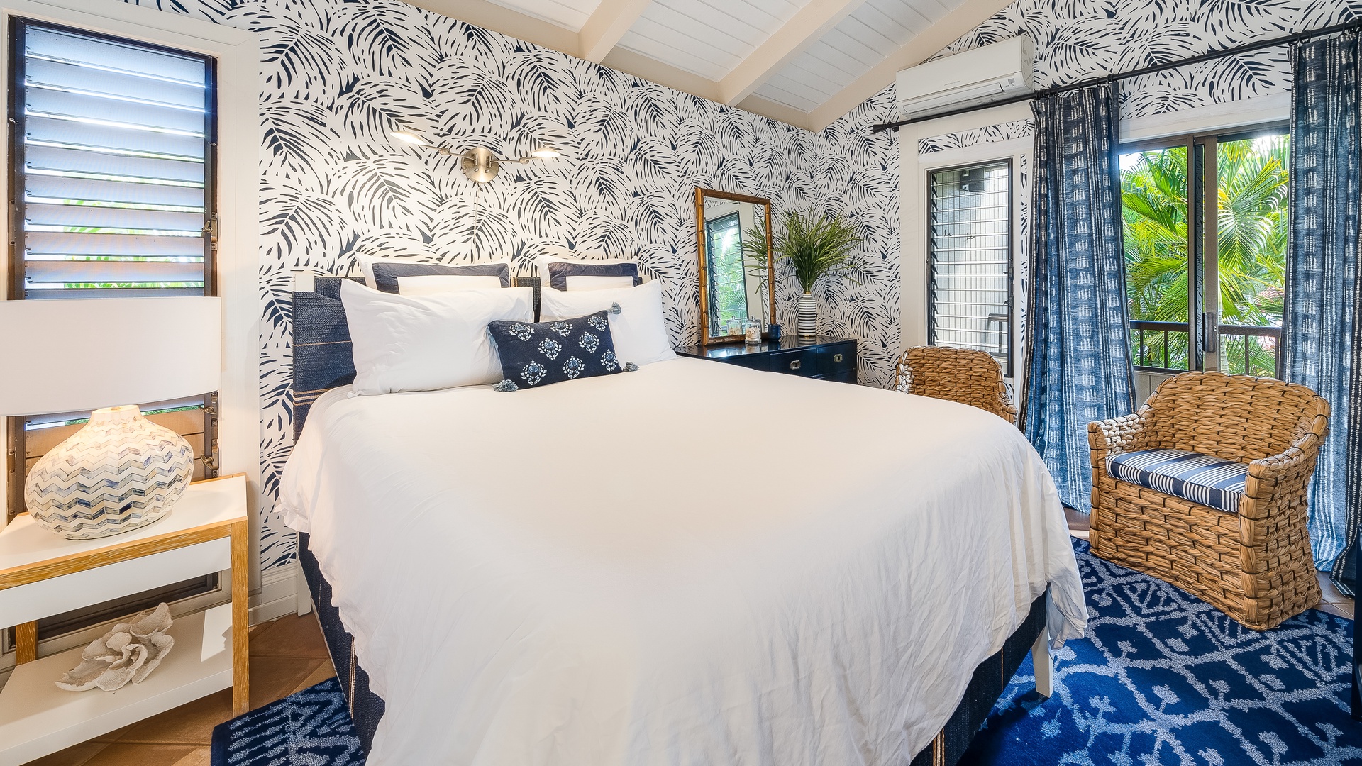 Kihei Vacation Rentals, Wailea Ekolu 1106 - The bedroom offers a cozy retreat with bold, tropical-inspired wallpaper and inviting natural light.