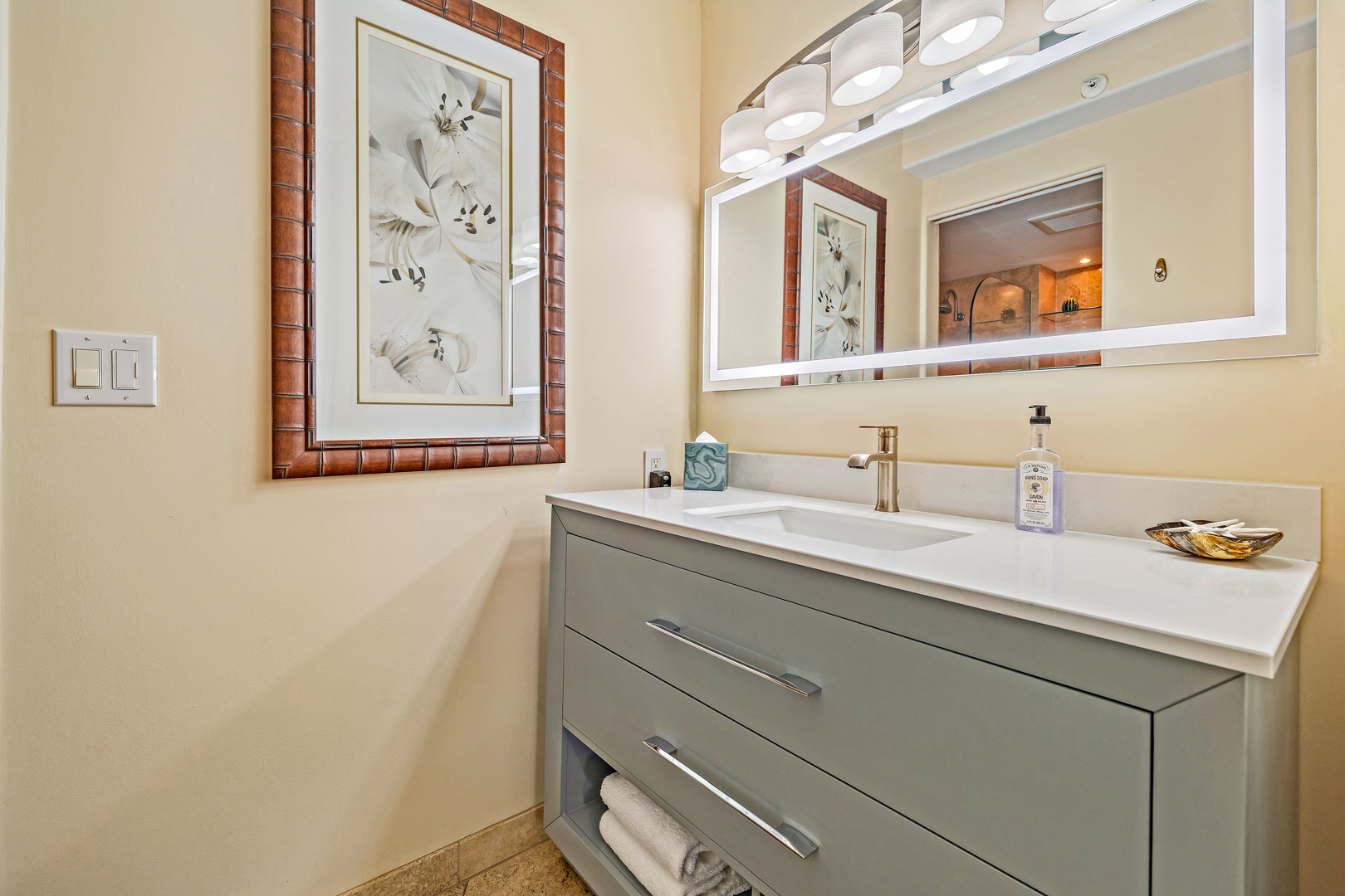 Lahaina Vacation Rentals, Royal Kahana 610 - The guest bathroom features a modern vanity with plenty of storage and bright lighting.