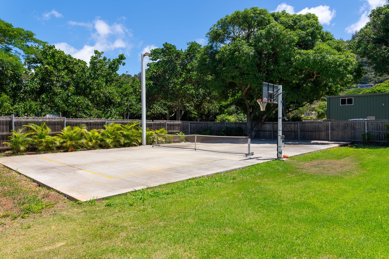 Haleiwa Vacation Rentals, Sunset Beach Island Retreat - A private outdoor pickleball court provides the perfect setting for a quick game of basketball or pickleball, offering both recreation and fitness opportunities amidst beautiful surroundings.