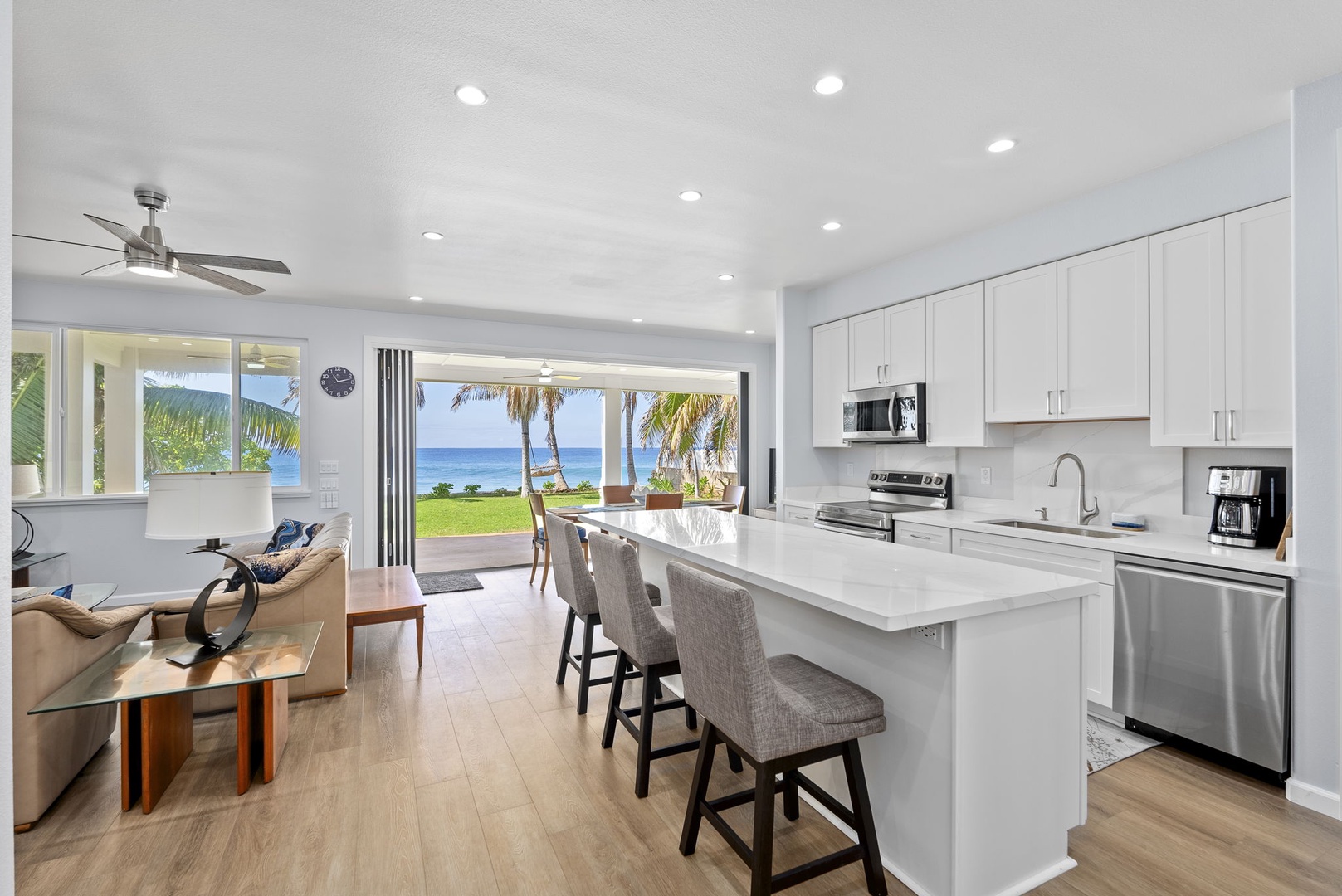 Waianae Vacation Rentals, Oceanfront Luxury Dream Estate - Lower-level kitchen opens to the dining area with bar seating and sliding doors to the lanai.