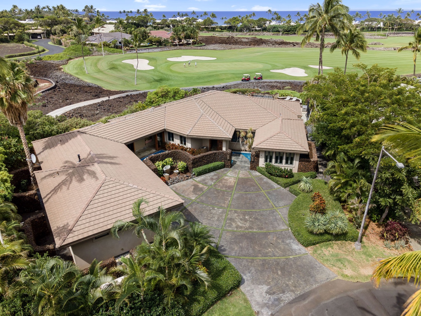 Kamuela Vacation Rentals, Hale Konane - Beautifully landscaped entrance framed by lush greenery and stunning golf course views.
