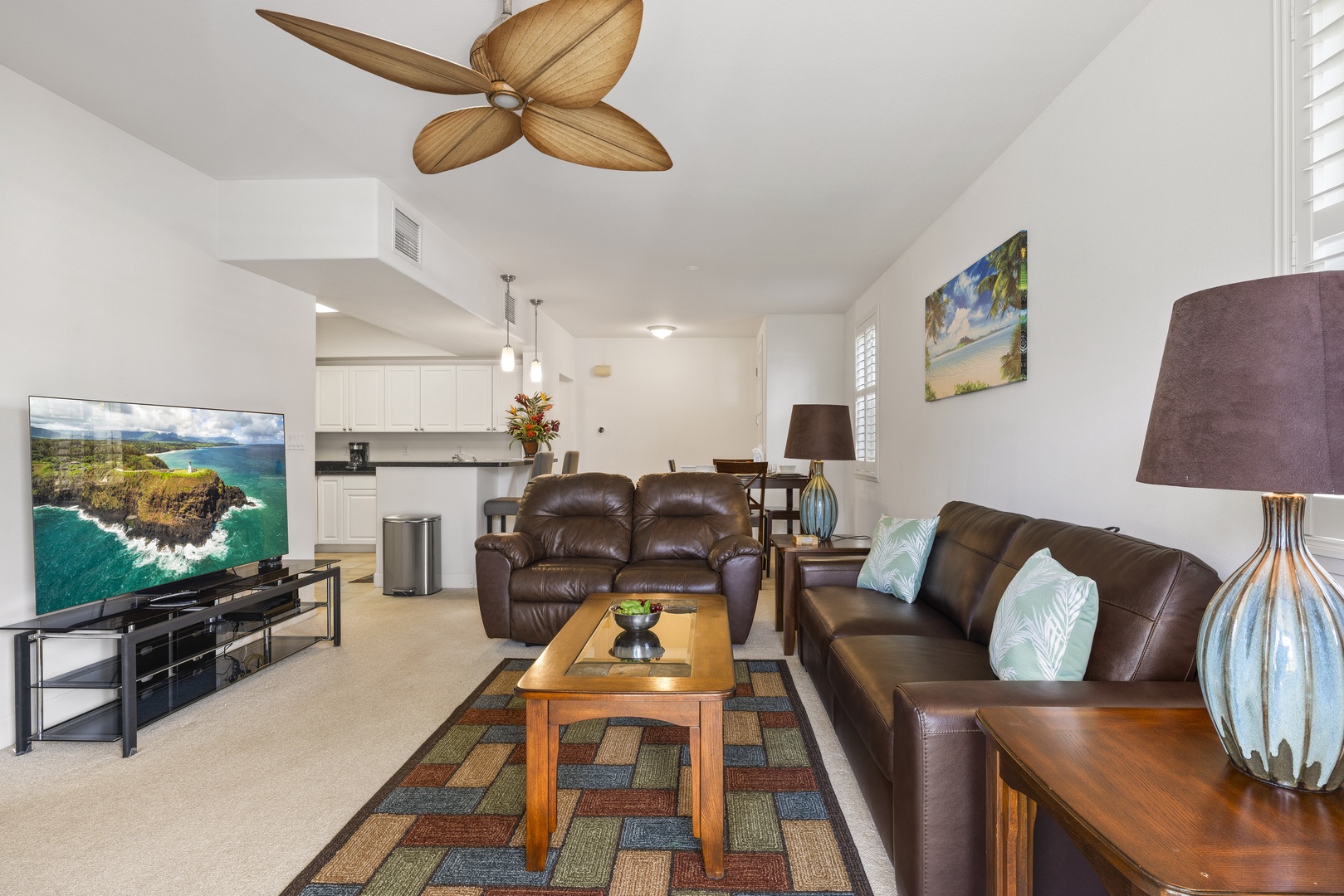 Relax in the comfortable living area, where plush seating and an open layout create an inviting space to unwind after a day exploring Oahu.