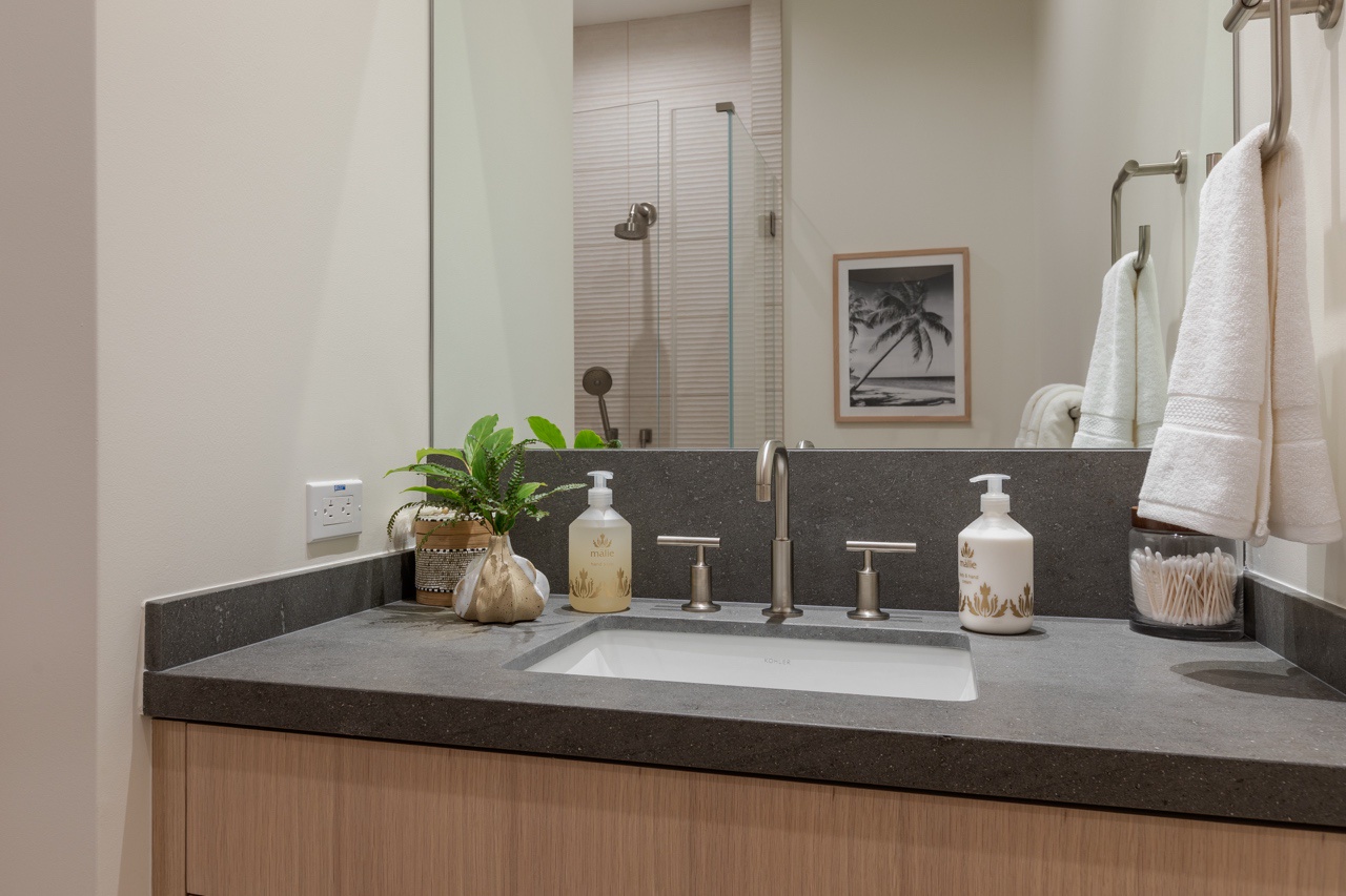 Waimea Vacation Rentals, 5BD Mauna Lani Lux Golf Estate (4) at One Ocean - This bathroom vanity is sleek and functional, featuring a clean design with a spacious countertop that provides ample room for toiletries.