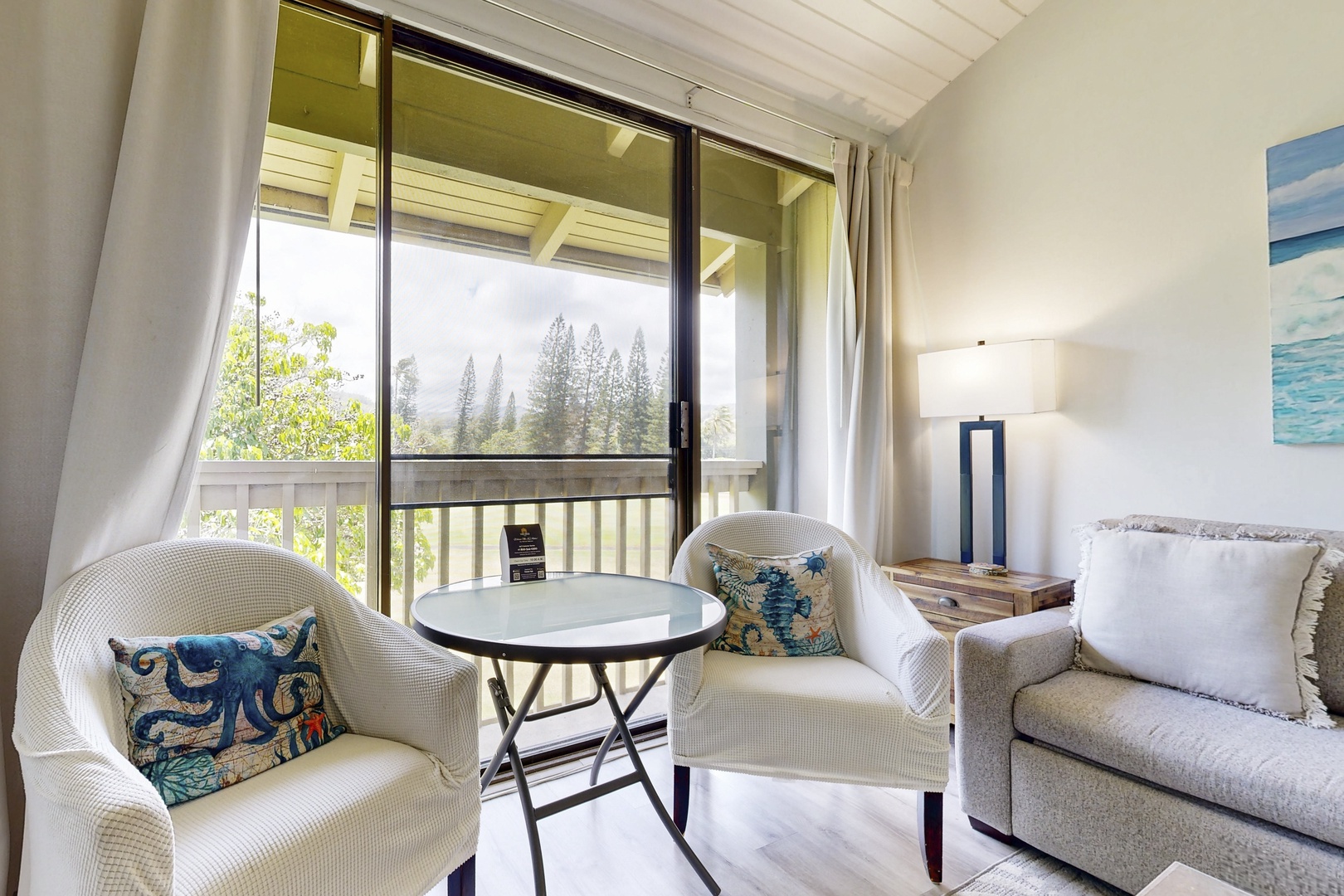 Kahuku Vacation Rentals, Kuilima Estates West #132 - Bright living area with large windows and garden views.