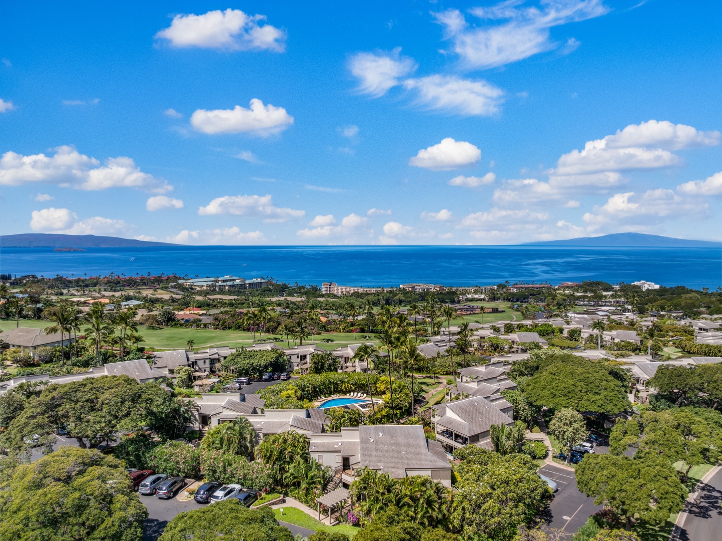Kihei Vacation Rentals, Wailea Ekolu 1106 - Aerial view of Wailea Ekolu 1106 grounds, surrounded by palms, ocean views, and open skies.