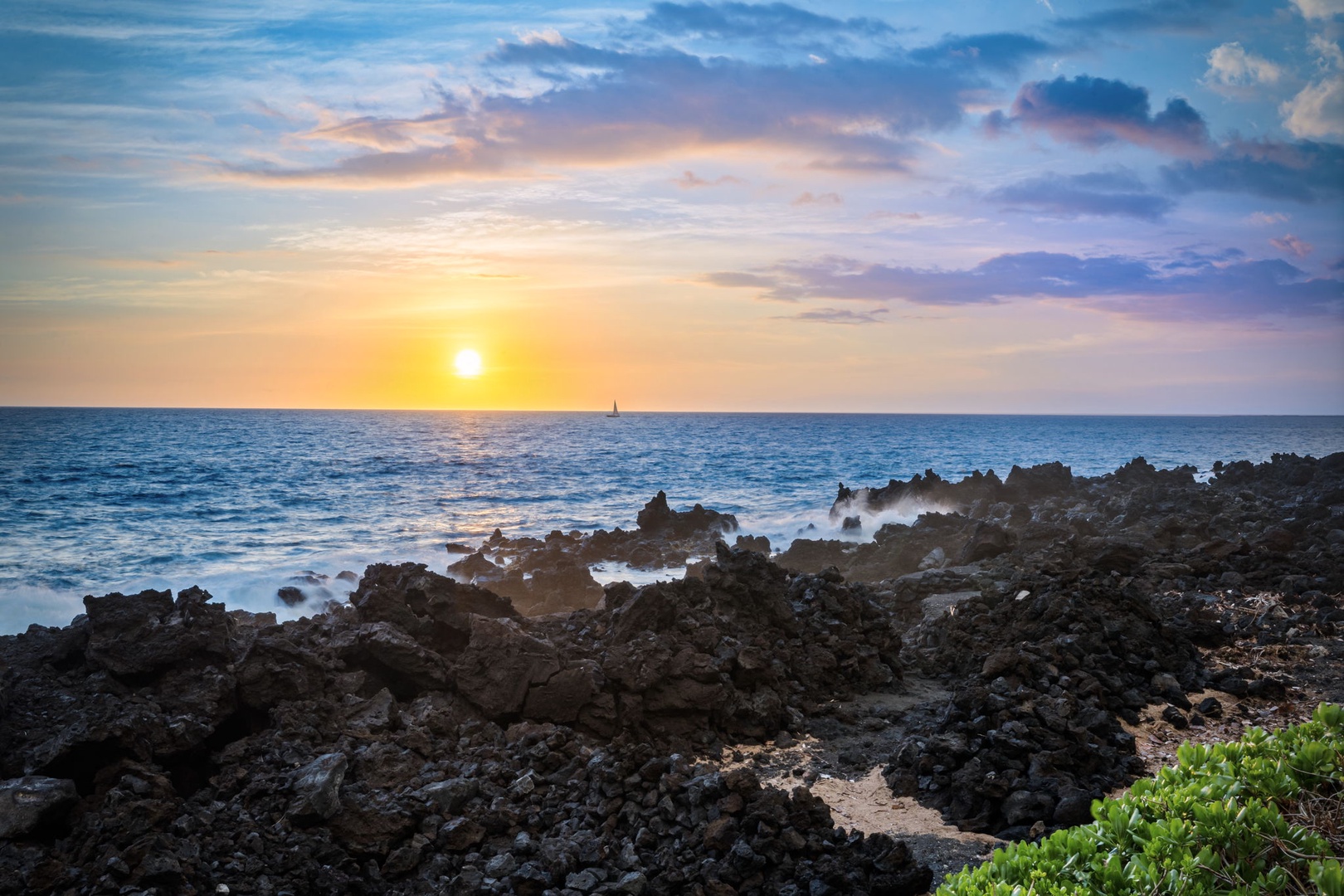 Kailua Kona Vacation Rentals, Kanaloa at Kona 1606 - The sun drops into the Pacific beyond the lava-rock shore.