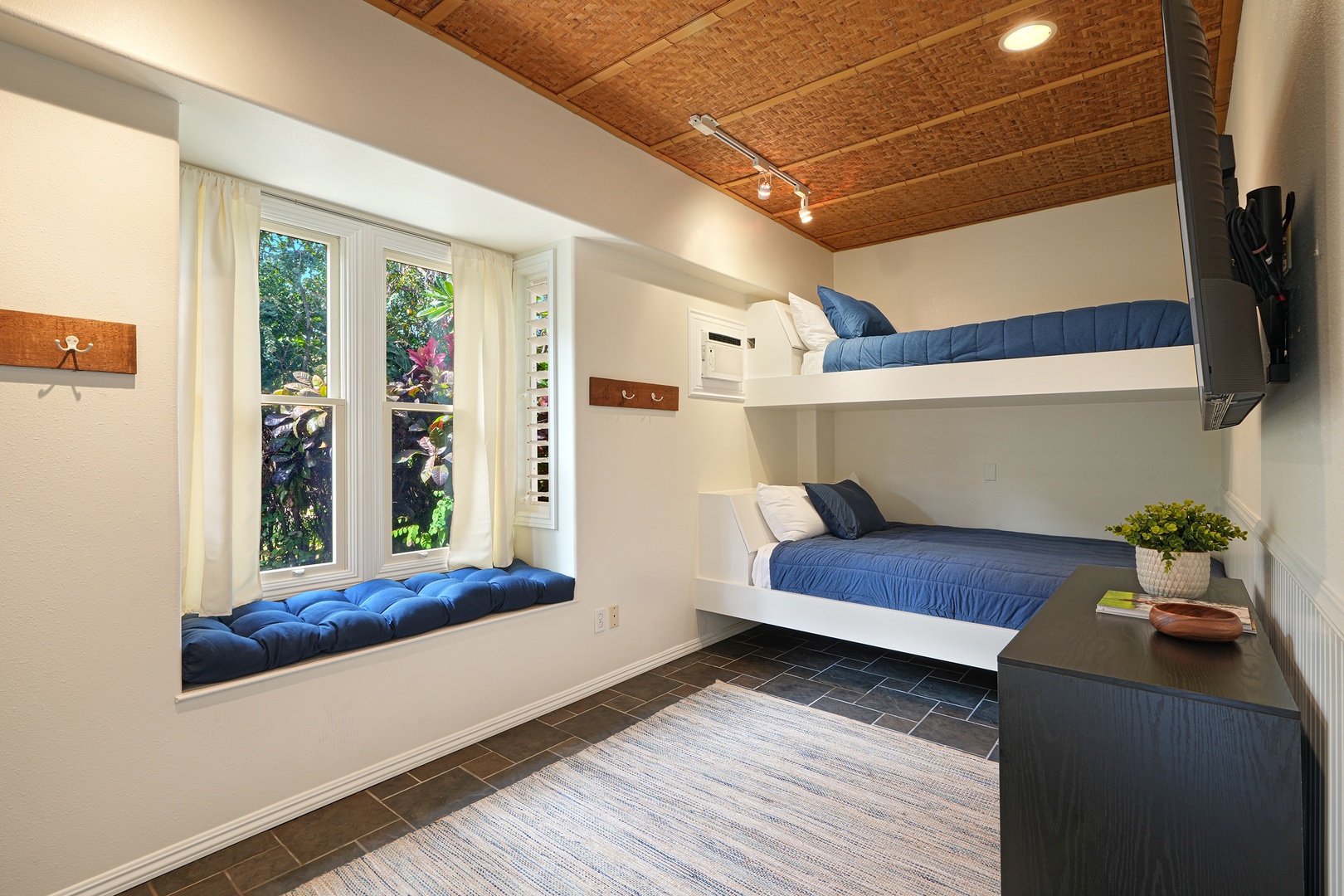 Koloa Vacation Rentals, Plantation Cottage at Poipu - Rest comfortably in your modern bunk room with built-in beds, cozy window seat, and garden views for a perfect getaway.