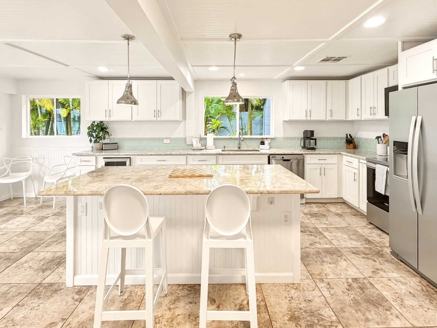 Honolulu Vacation Rentals, Ho'okipa Villa - Your dream kitchen awaits with gleaming granite counters, premium appliances, and tropical garden views through bright windows.