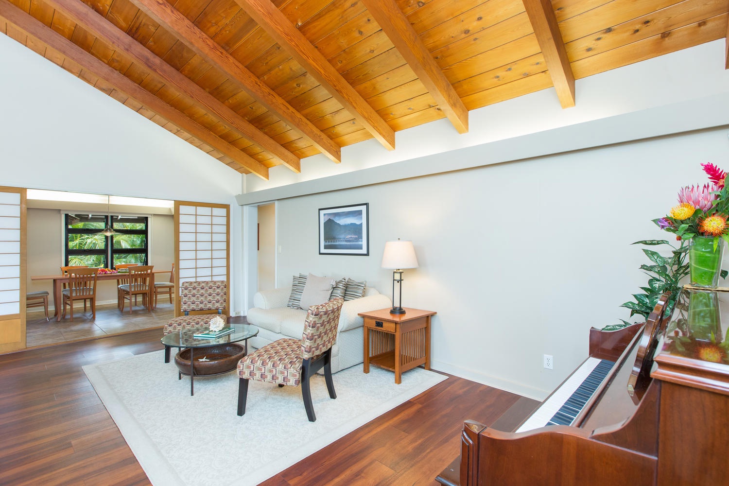 Honolulu Vacation Rentals, Hale Poola - Spacious open-concept living area complete with a TV, seamlessly leading to the dining room in the backdrop.