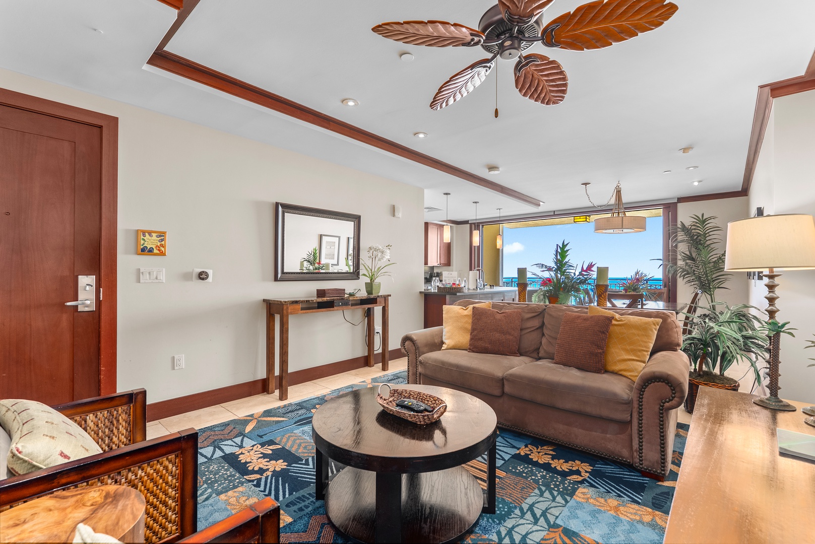 Kapolei Vacation Rentals, Ko Olina Beach Villas O1404 - A soft brown sofa turned toward the windows, the day's light coming in easy.
