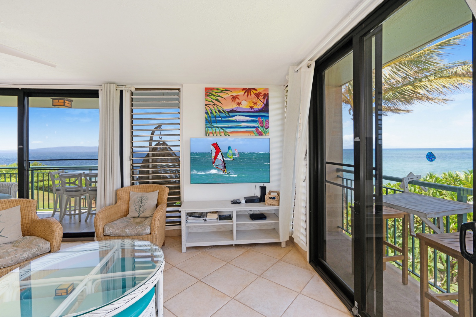 Kihei Vacation Rentals, Punahoa Beach 205 - A palm frond dips into view right outside the sliding door, ocean stretching beyond.