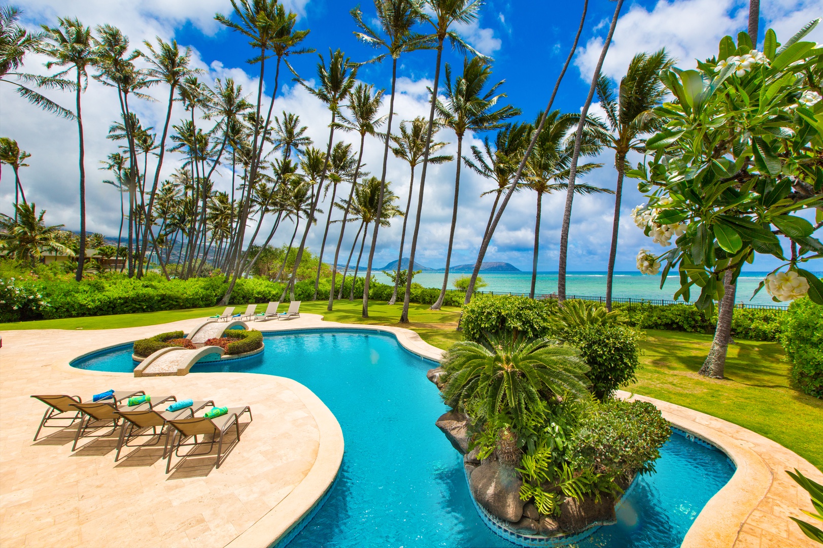 Honolulu Vacation Rentals, Kahala Mini Resort (5BR) - The freeform pool meanders beneath the coconut palms on its way toward the sea.