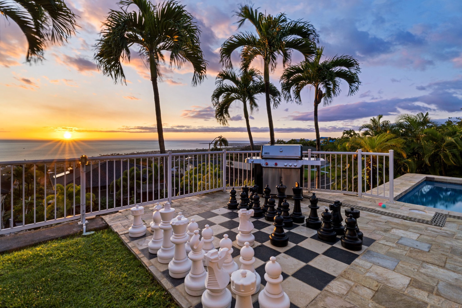 Kailua-Kona Vacation Rentals, Honu Hale - Stunning sunset views frame this tropical terrace with giant chess, BBQ grill, and sparkling pool - your perfect evening escape.