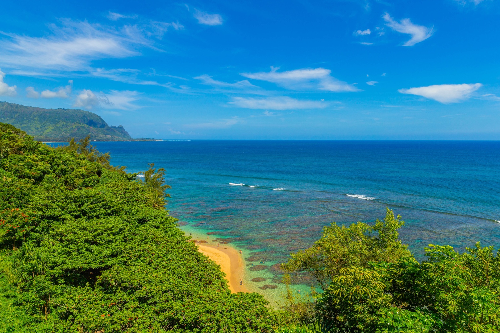 Princeville Vacation Rentals, Ola Hou - Entire Property - A breathtaking view of the turquoise ocean surrounded by lush greenery.