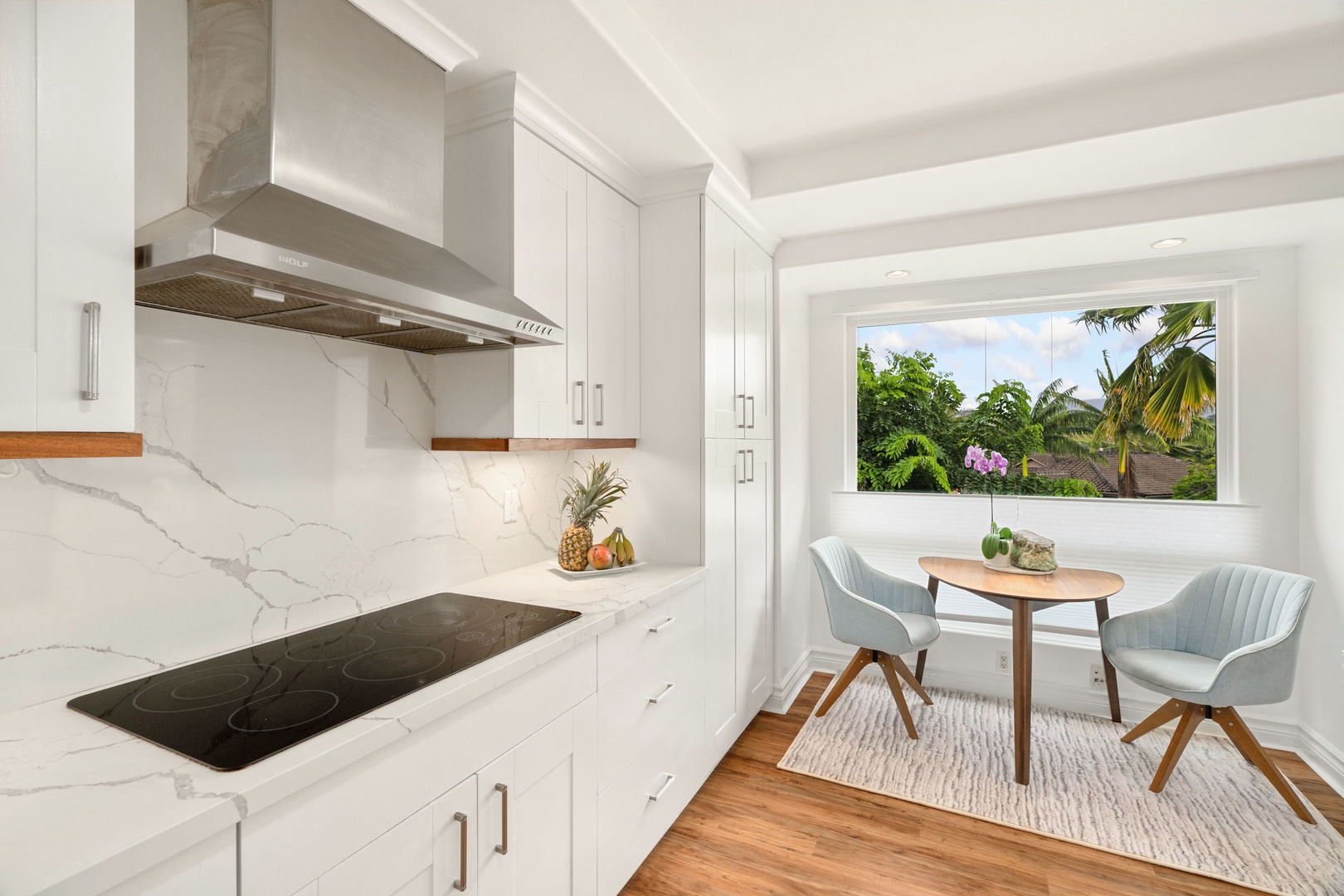 Princeville Vacation Rentals, Tropical Elegance - Sleek kitchen with a breakfast nook, perfect for vacation culinary adventures and shared quick meals.