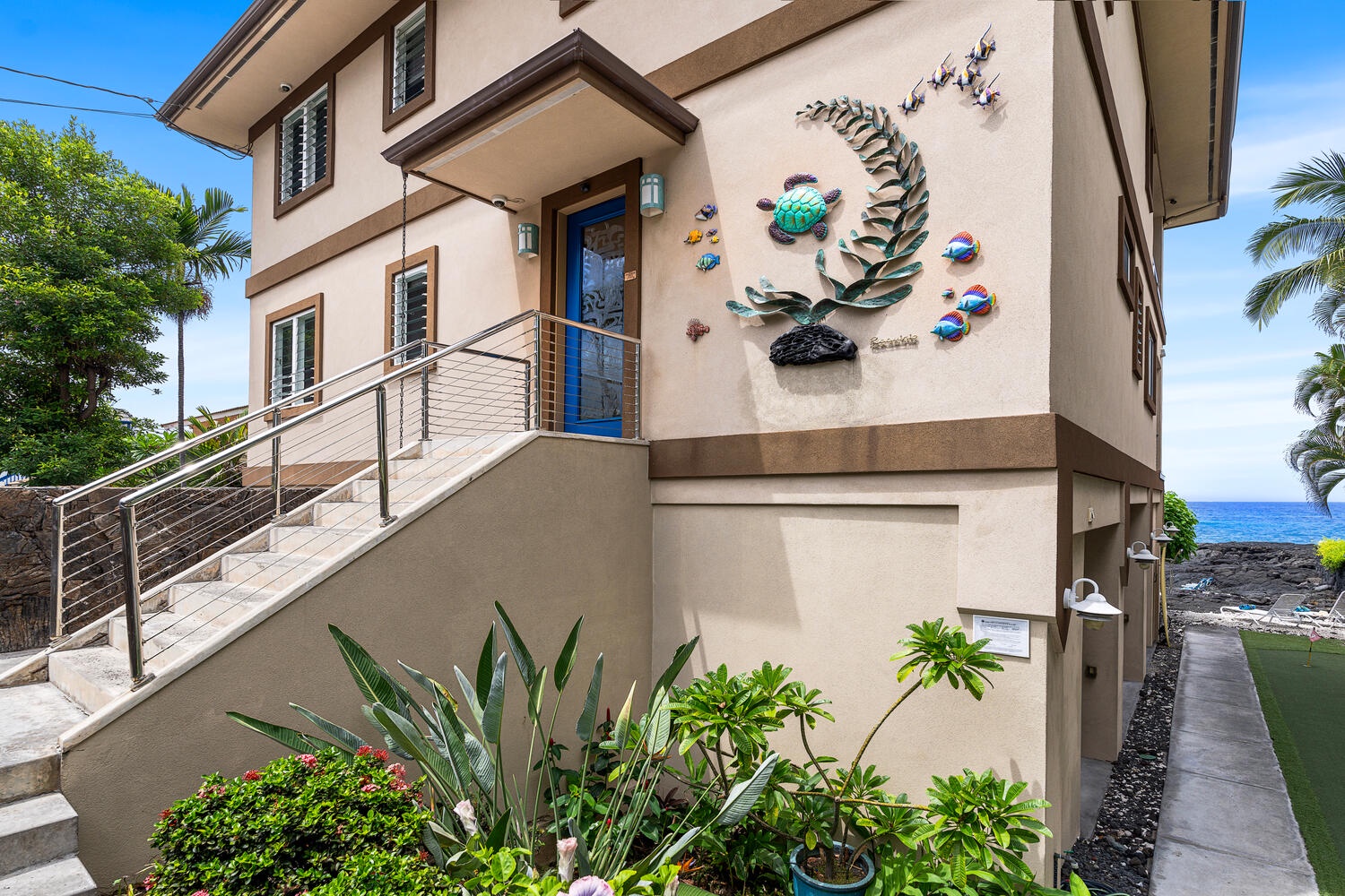Kailua Kona Vacation Rentals, Kailani Vista - A lava-rock wall and custom sea-turtle plaque signal you’ve arrived at your own private slice of Ali'i Drive—secure, secluded, and steps from the surf.