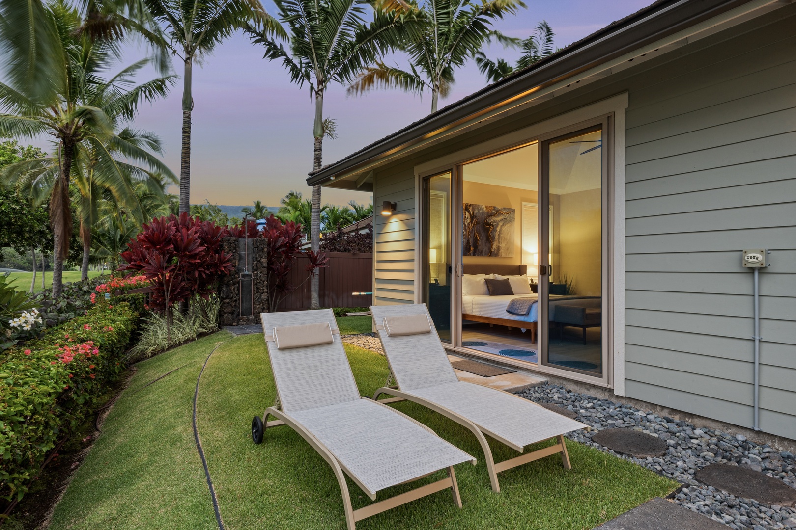 Kailua Kona Vacation Rentals, Holua Kai #27 - Loungers face the last of the light as the garden goes quiet for the night.