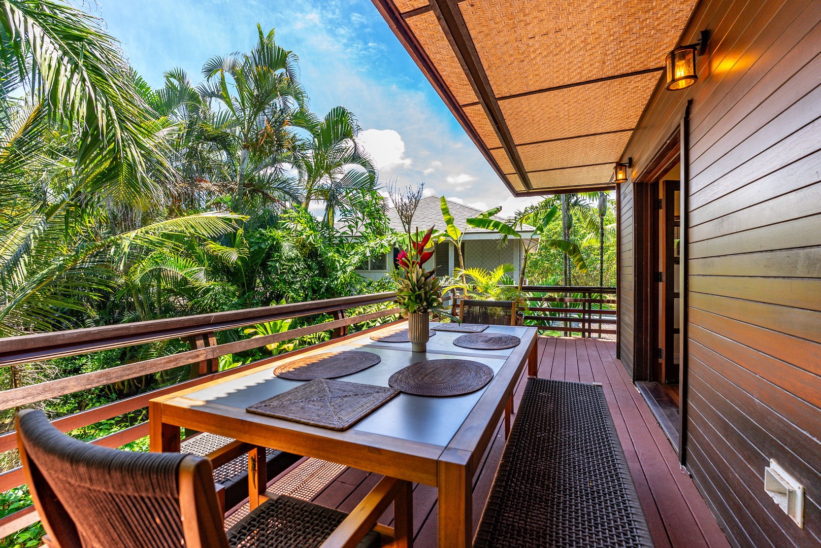 Haleiwa Vacation Rentals, Kealoha Tropical Beach Villa - The wrap around deck with outdoor dining is accessible through the living area.