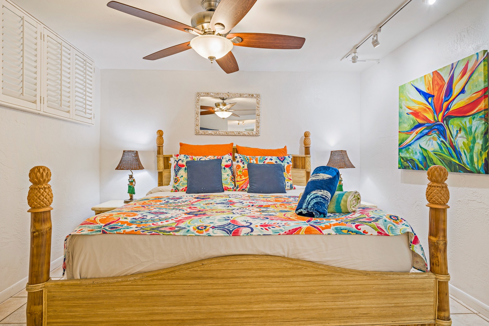 Lahaina Vacation Rentals, Papakea L-106 - A vibrant and cozy bedroom with tropical decor, featuring a comfortable bed perfect for unwinding after a day of exploring