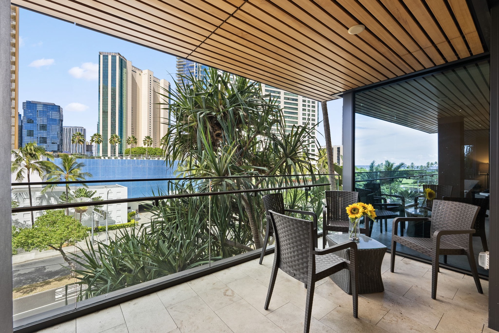 Honolulu Vacation Rentals, Park Lane Getaway - Comfortable seating on the lanai – unwind while enjoying the skyline.