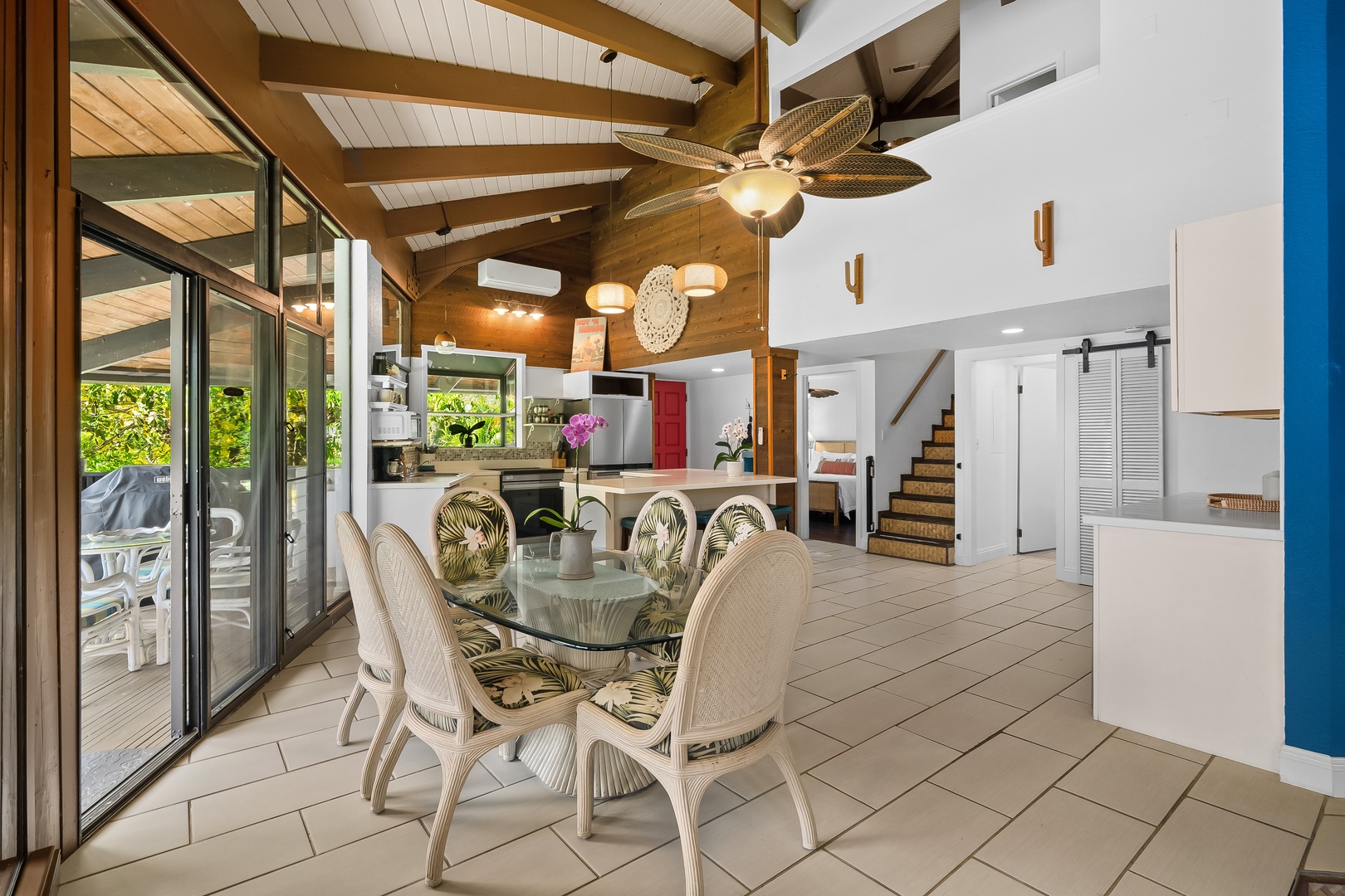 Princeville Vacation Rentals, Mauna Kai 7B - Gather around glass and rattan while the open kitchen keeps everyone in on dinner.