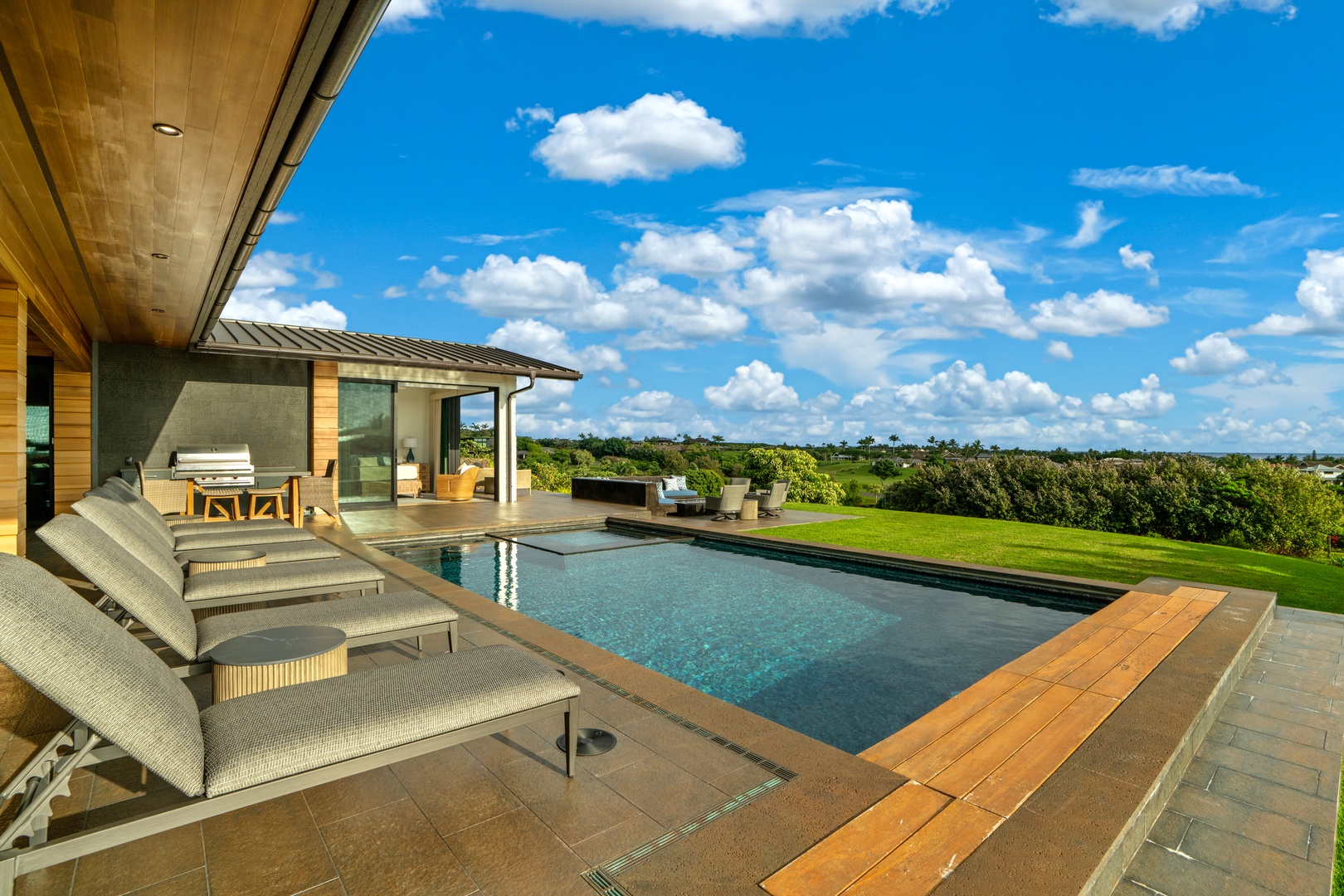 Koloa Vacation Rentals, Hale Laule'a at Kukui'ula - Modern pool terrace offers pristine swimming with expansive views over lush landscapes and rolling countryside.