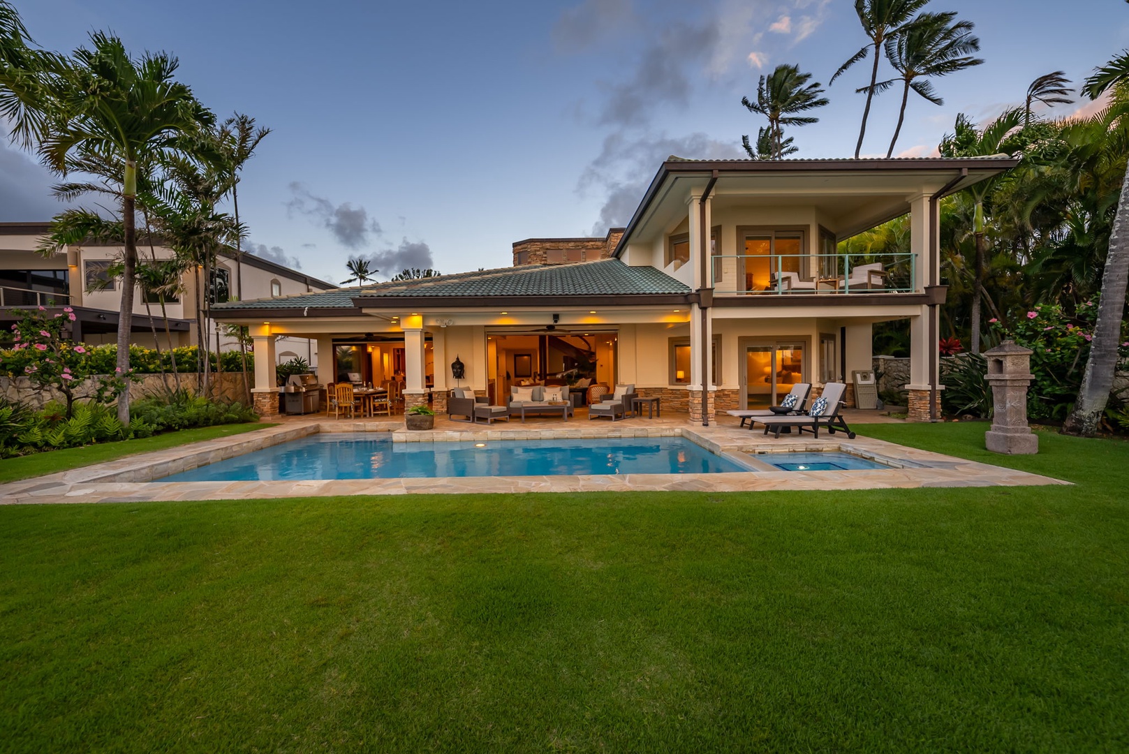 Honolulu Vacation Rentals, Maunalua Estate - Evening light glows across the pool and covered lounge, creating a warm island atmosphere.