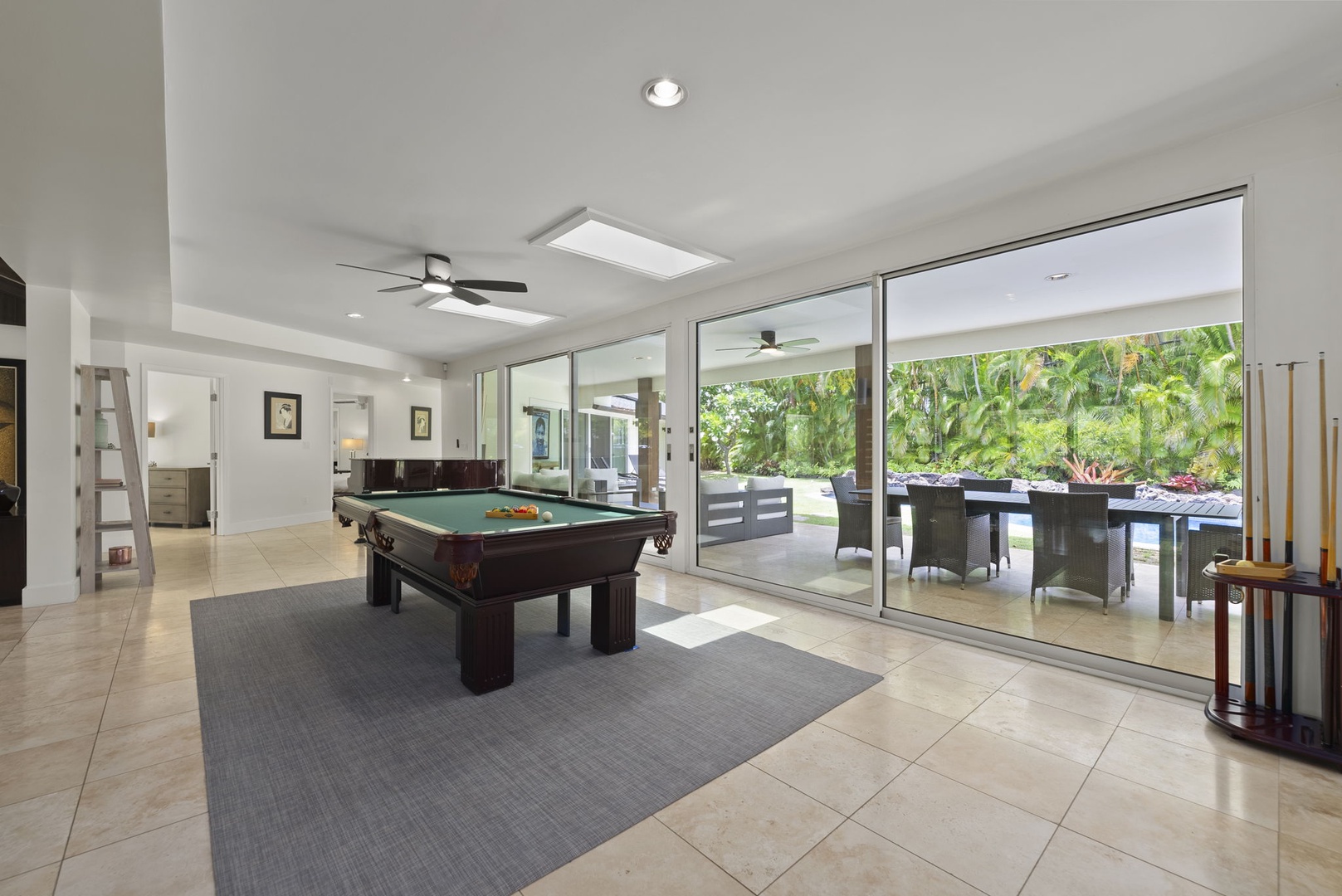 Honolulu Vacation Rentals, Kahala Lani - Breezy game lounge with direct lanai access—step outside for a swim or stay in for play.