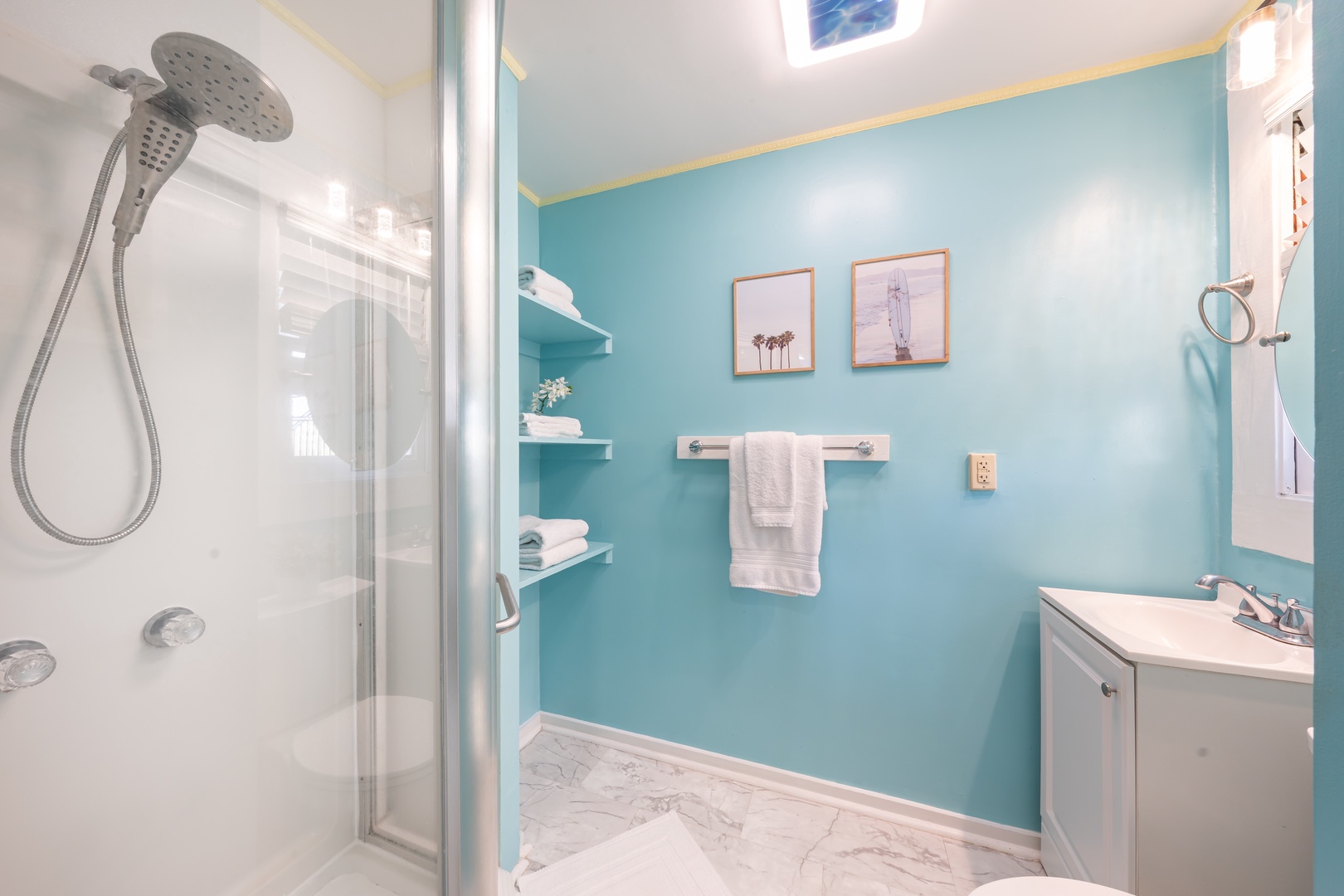 Hauula Vacation Rentals, Private Beach Paradise - A glass walk-in shower with a rain head, all in cool ocean blue.