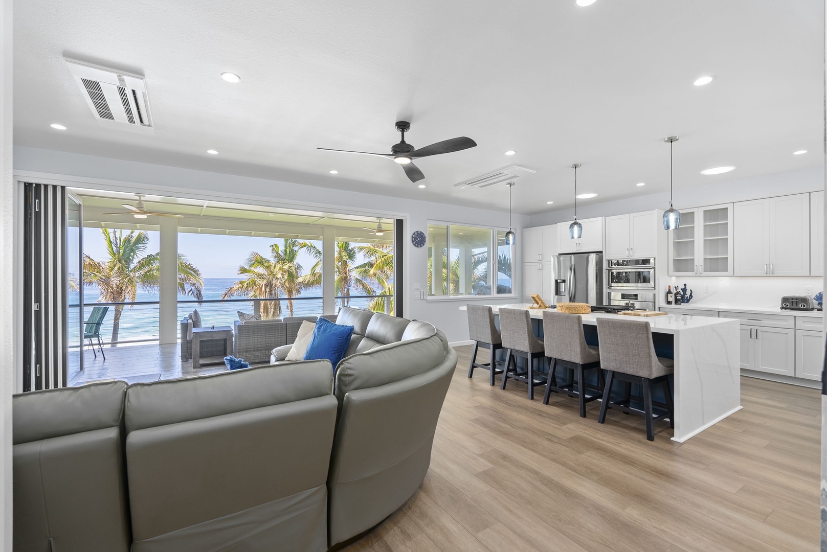 Waianae Vacation Rentals, Oceanfront Luxury Dream Estate - Open-concept living and kitchen area with panoramic windows and designer furnishings.