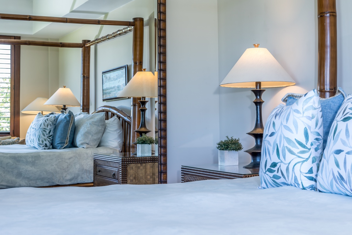 Kailua Kona Vacation Rentals, Fairways Villa 120A - Sink into crisp white linens and tropical-print pillows in your serene bedroom, where warm bedside lighting creates the perfect ambiance for relaxation.