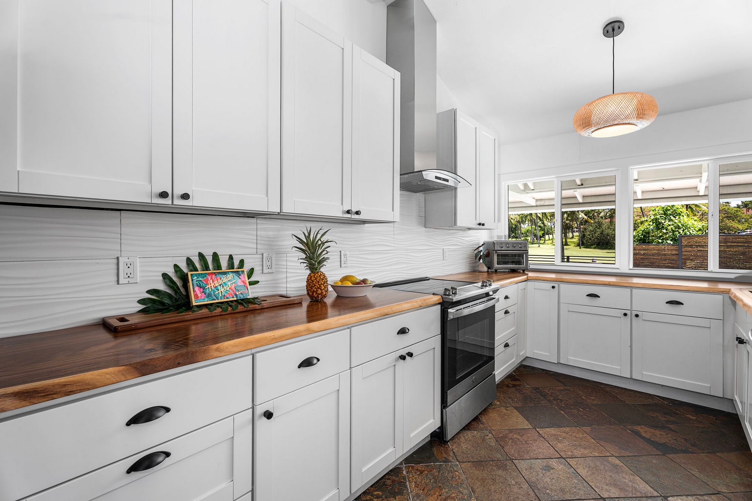 Kailua Kona Vacation Rentals, Manukai Hale - Counter to counter, the kitchen runs long enough for morning Kona coffee and a full meal.