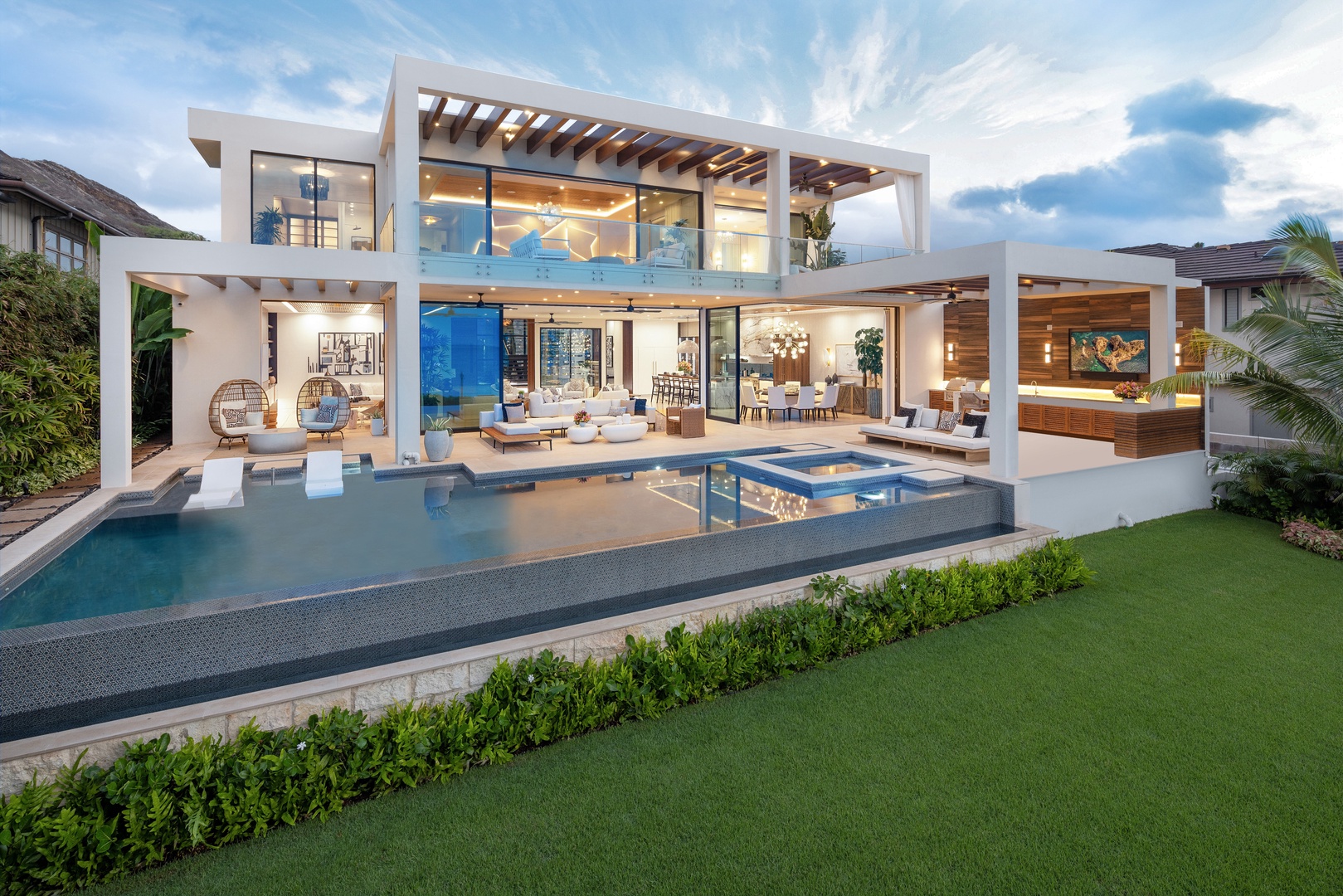 Honolulu Vacation Rentals, Diamond Head Grand Escape - As evening falls, the infinity pool and illuminated exterior create an enchanting ambiance.