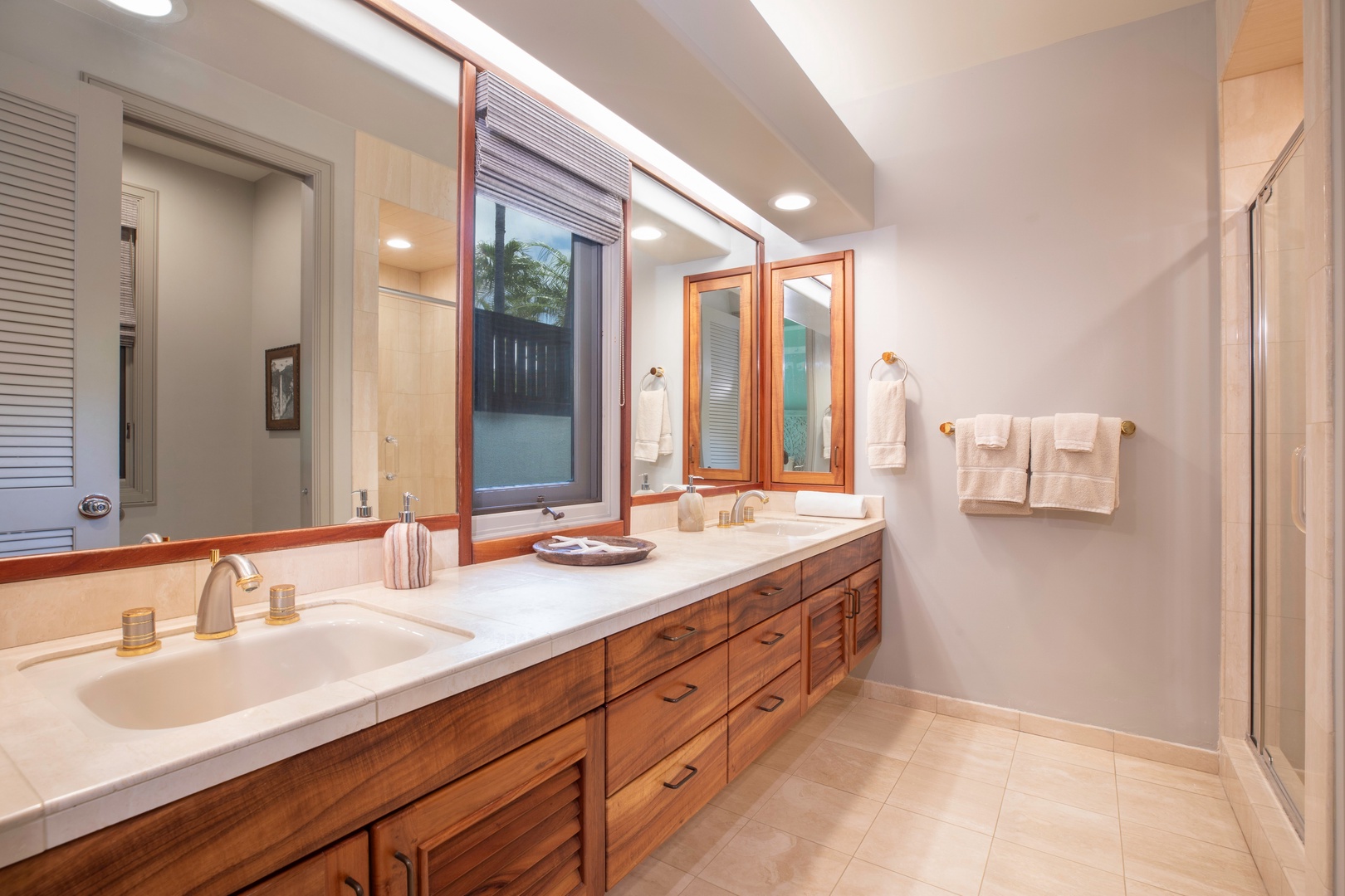 Kamuela Vacation Rentals, Canoe House at Champion Ridge - Guest bathroom with dual sinks, a large mirror, and natural light, offering a comfortable and functional space.