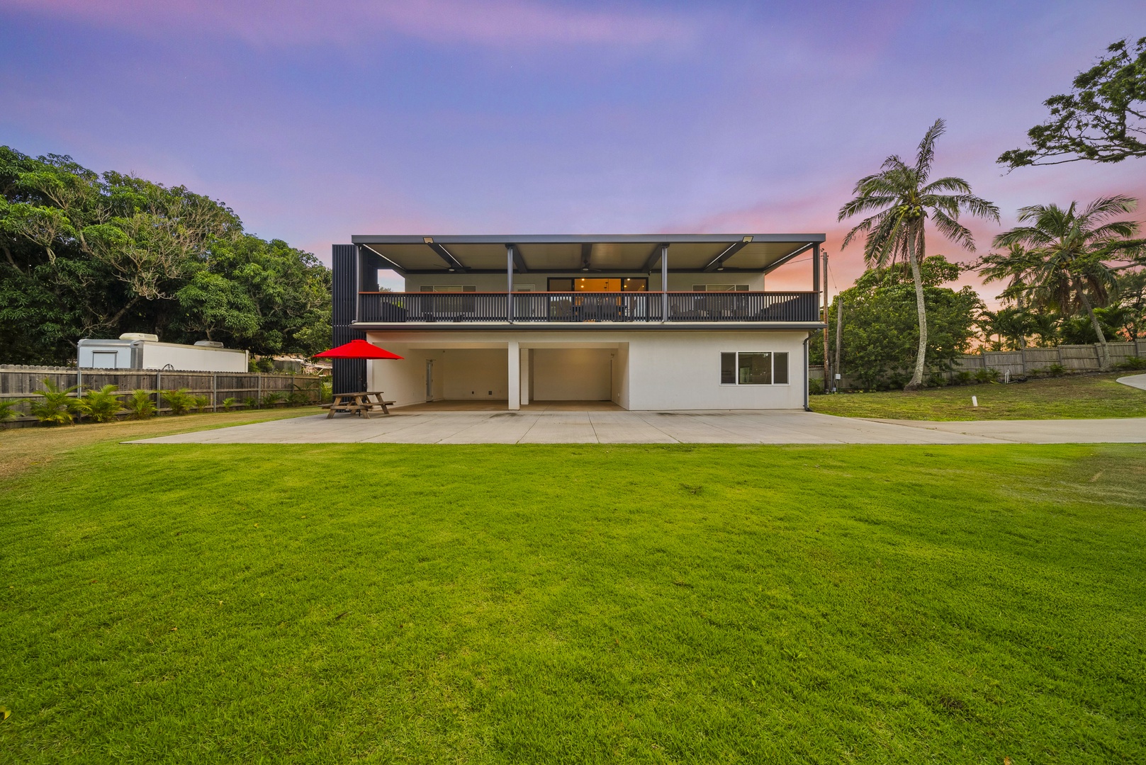 Haleiwa Vacation Rentals, Sunset Pickleball Paradise - Expansive lawn surrounding the home creates a peaceful environment, perfect for recreation or unwinding.