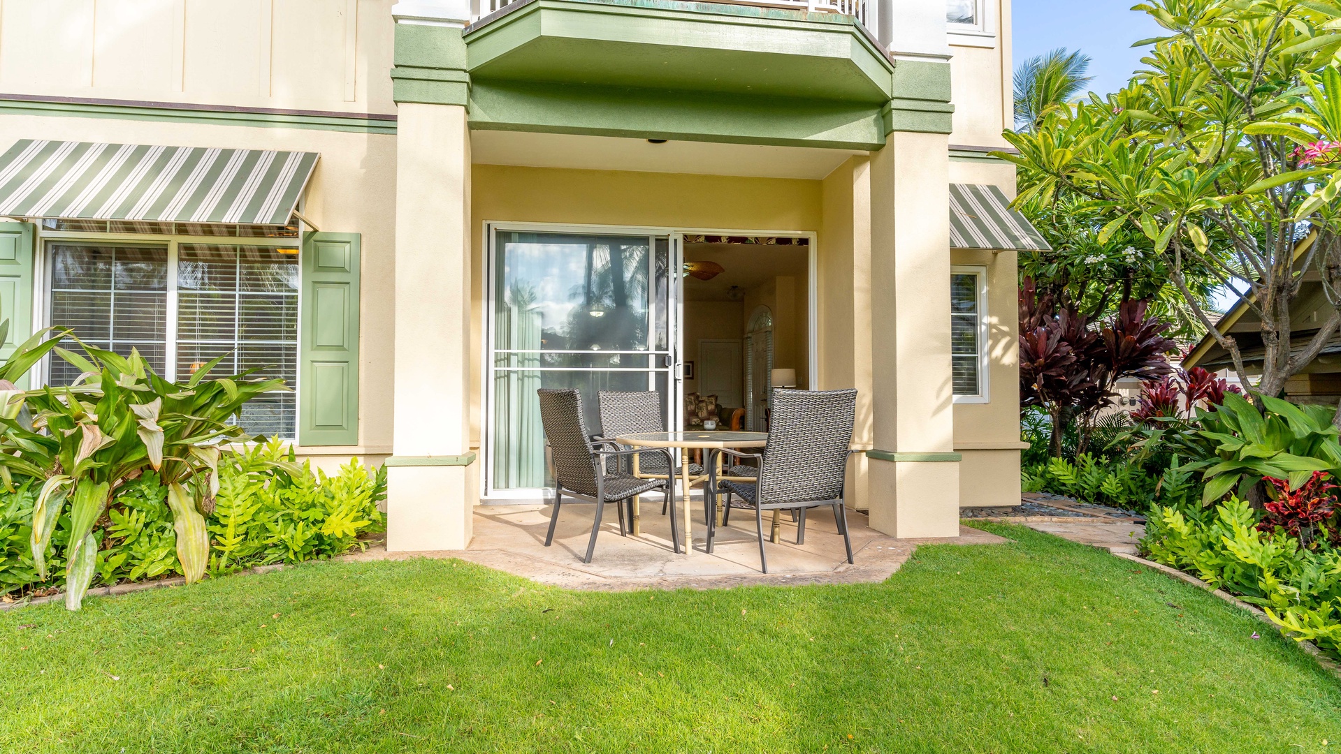 Kapolei Vacation Rentals, Kai Lani 8B - A manicured lawn and sun dappled table.