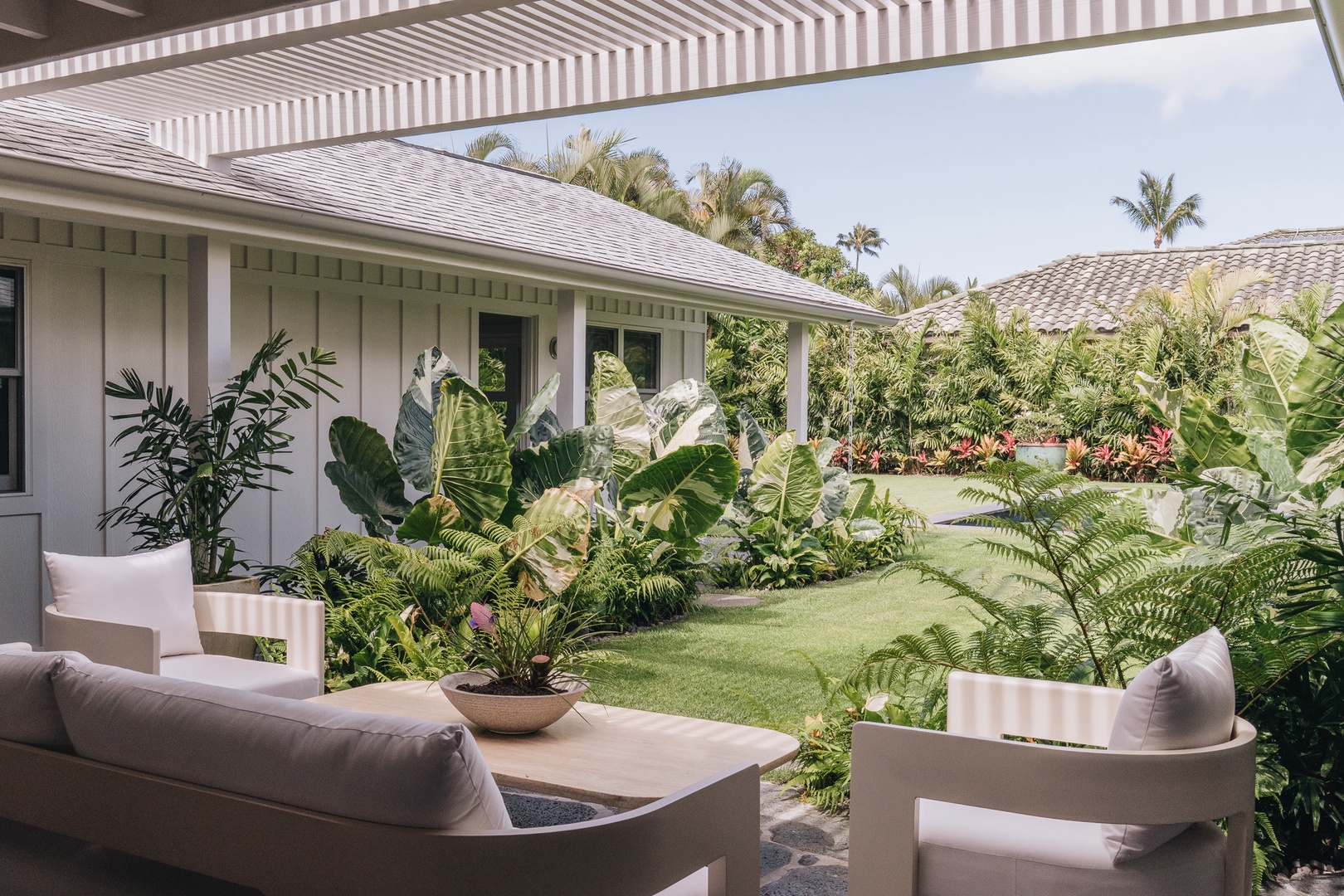 Honolulu Vacation Rentals, Surfside Bungalow** - Surrounded by tropical greenery, this peaceful outdoor setting invites you to slow down and unwind.